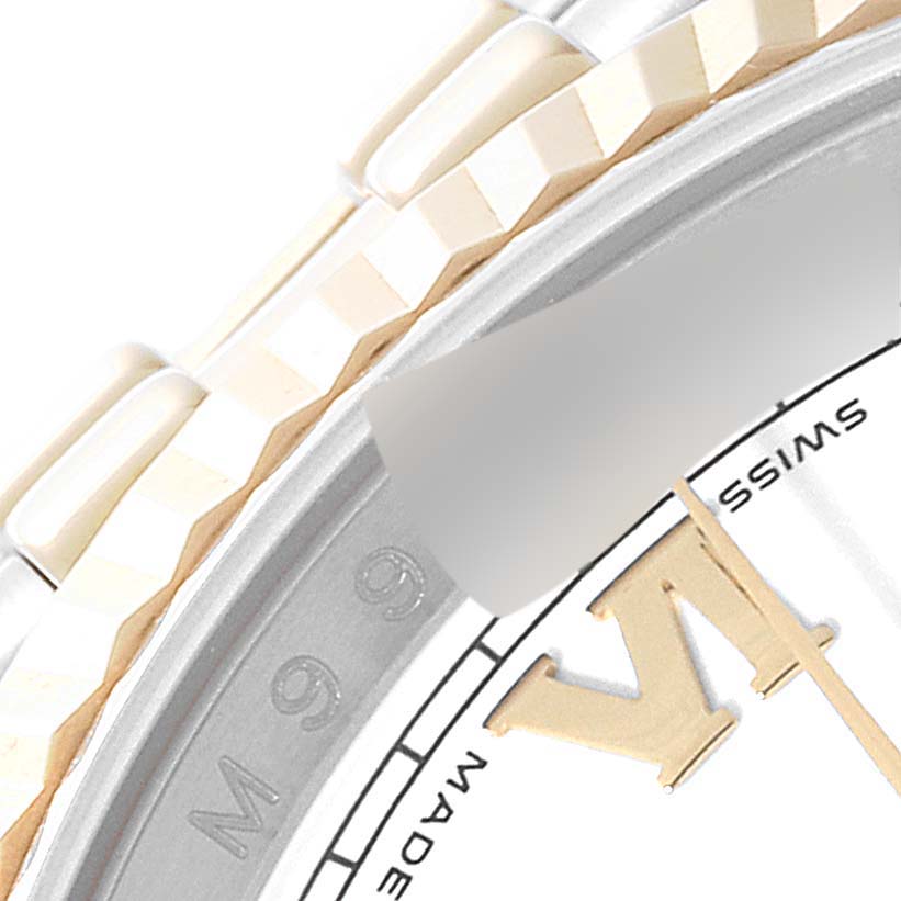 This image shows a close-up of the bezel, bracelet, and part of the dial of a Rolex Datejust 116233 Men's Steel and Gold (two tone) White Dial 116233 Men's Steel and Gold (two tone) White Dial watch.