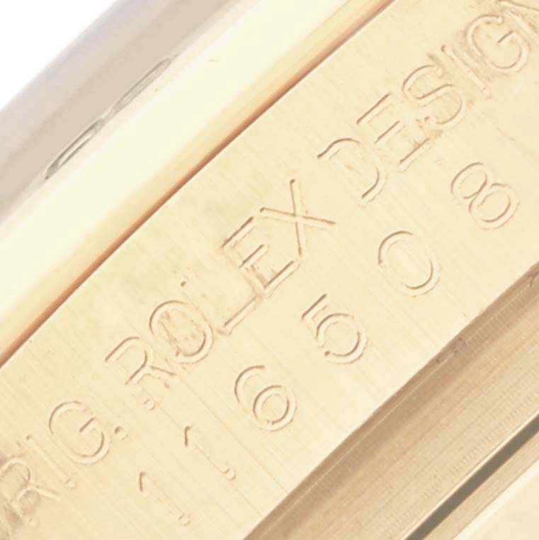 The image shows an angled close-up of the engraved side of a Rolex Daytona 116508 Men
s Yellow Gold Black Dial 116508 Men
s Yellow Gold Black Dial watch, highlighting the branding and model details.