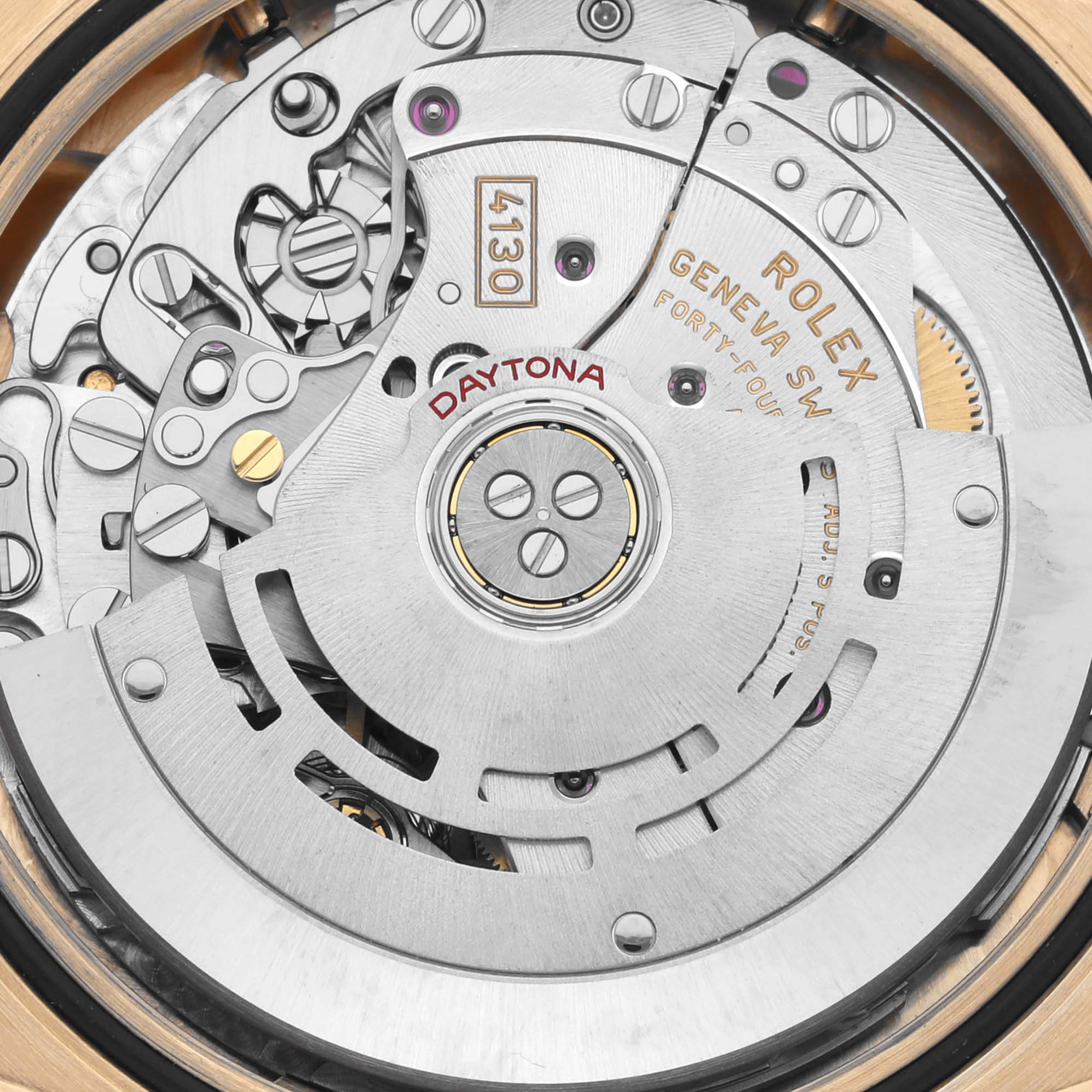The image shows a close-up of the movement of a Rolex Daytona 116508 Men
s Yellow Gold Black Dial 116508 Men
s Yellow Gold Black Dial, highlighting its intricate mechanics and engravings.