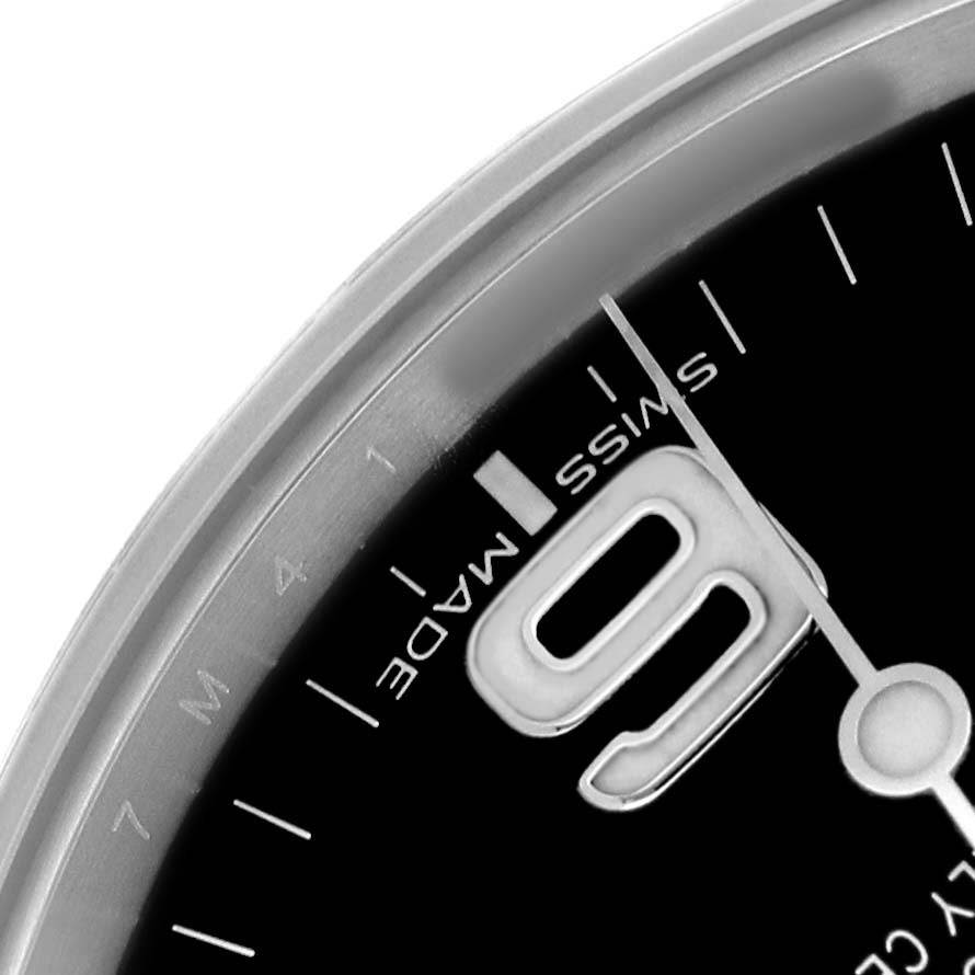 The image shows a close-up of the Rolex Explorer 214270 Men's Stainless Steel Black Dial's dial, focusing on the "9" and "Swiss Made" text.