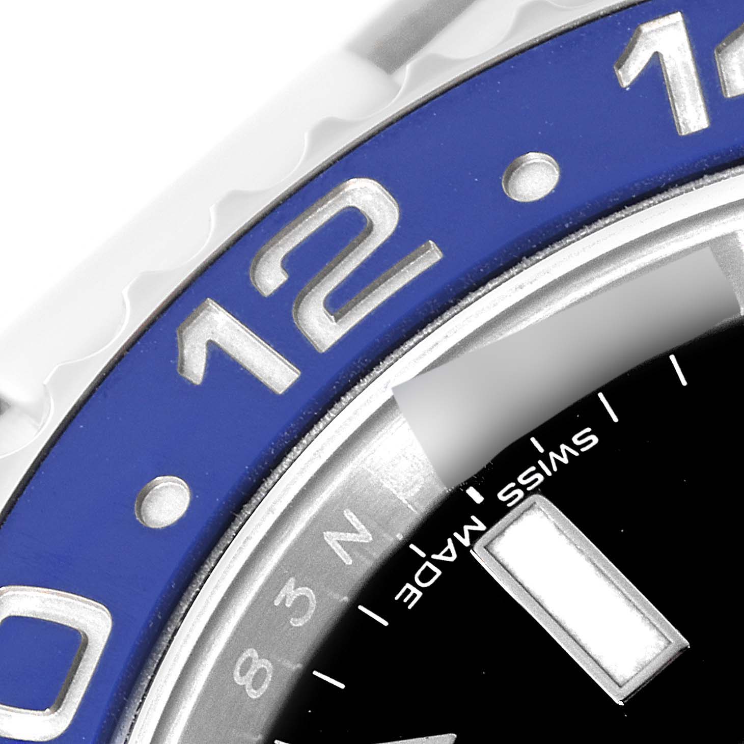Close-up of the bezel and dial of a Rolex GMT-Master 116710 Men
s Stainless Steel Black Dial 116710 Men
s Stainless Steel Black Dial, showing the "12" marker, part of the "Swiss Made" text, and 24-hour markings.