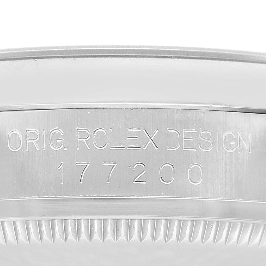 The image shows a close-up of the case side of a Rolex Mid-Size 177200 Women's Stainless Steel Purple Dial model, displaying the engraved model number and design text.