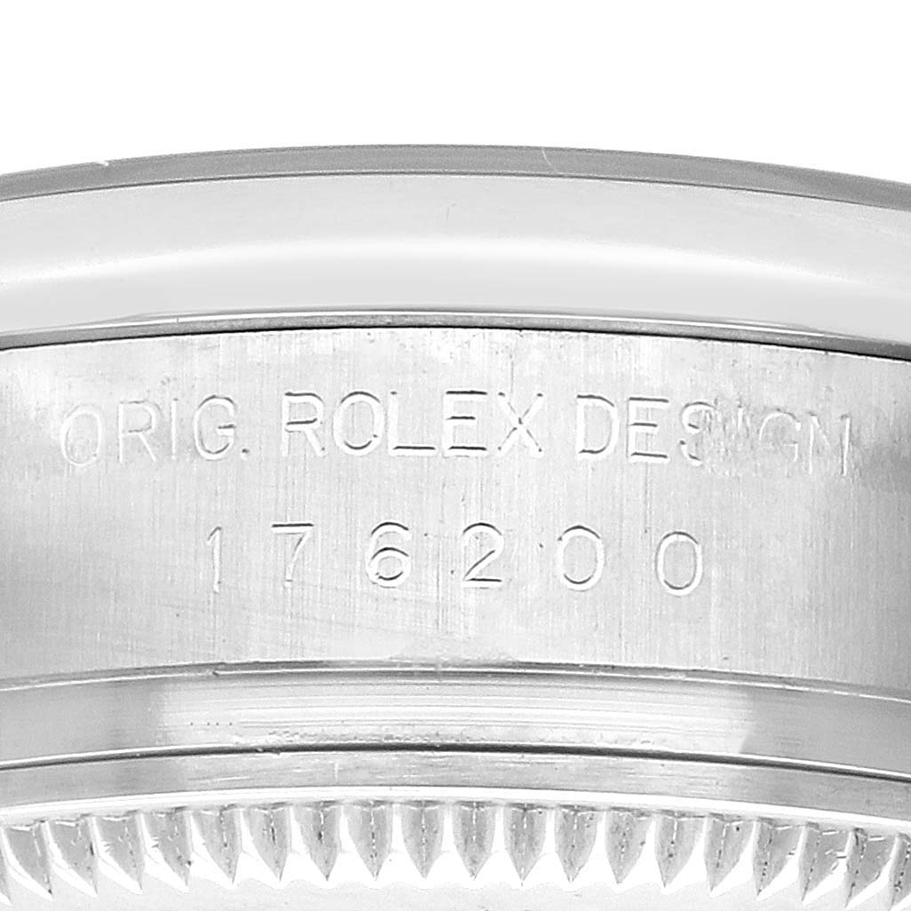 The image shows a close-up of the side of a Rolex Oyster Perpetual 176200 Women
s Stainless Steel White Dial 176200 Women
s Stainless Steel White Dial watch, highlighting the engraved model number and design details.