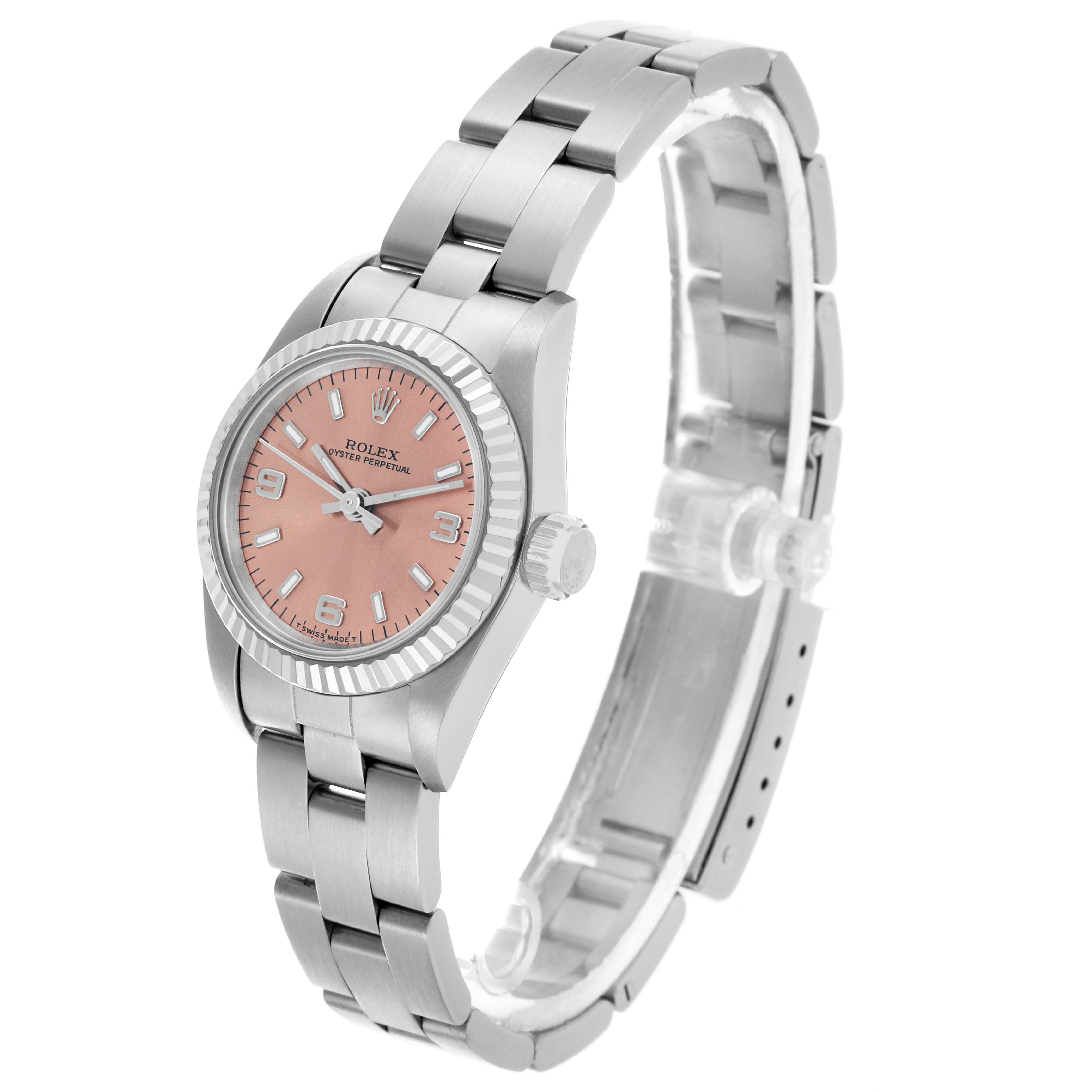 The Rolex Oyster Perpetual 67194 Women's Steel and Gold (two tone) Orange Dial 67194 Women's Steel and Gold (two tone) Orange Dial watch is shown from a side angle, displaying its pink dial and silver bracelet.