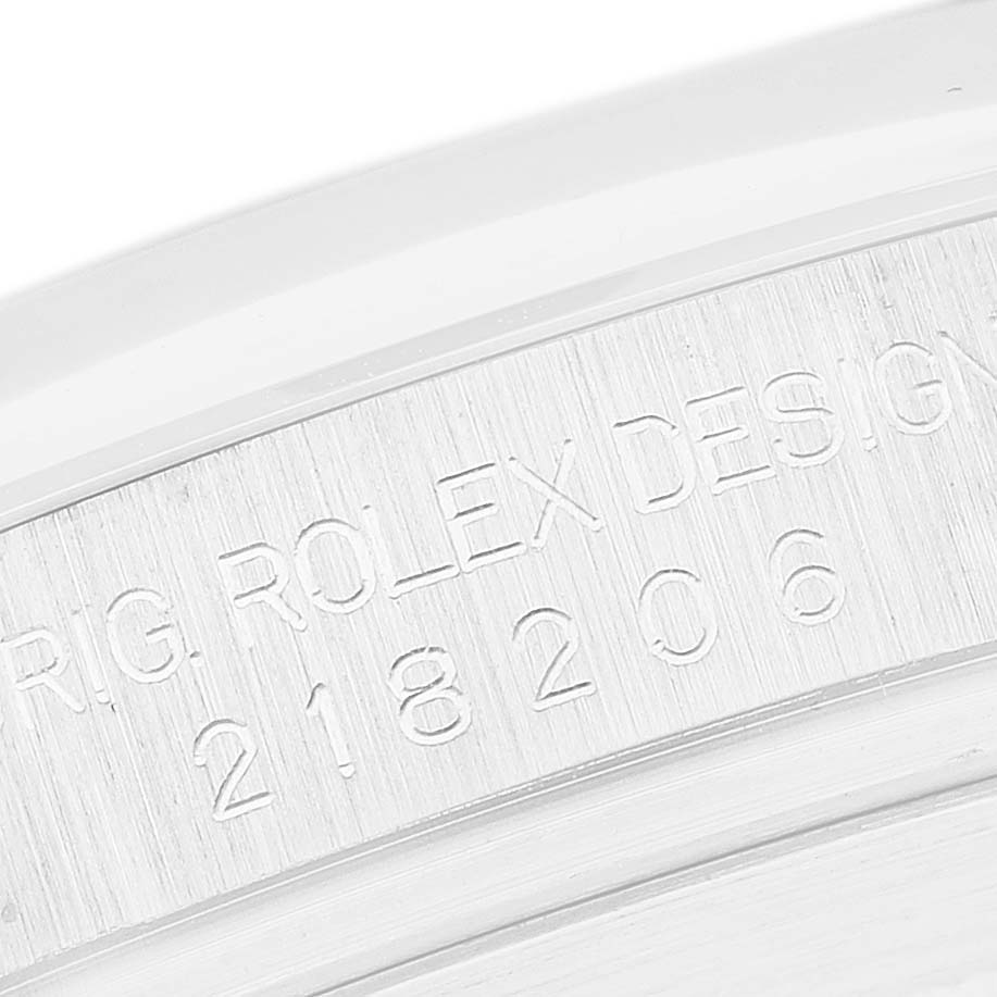 The image shows a close-up of the inner rim engraving on a Rolex President 218206 Men's Platinum Blue Dial model watch.