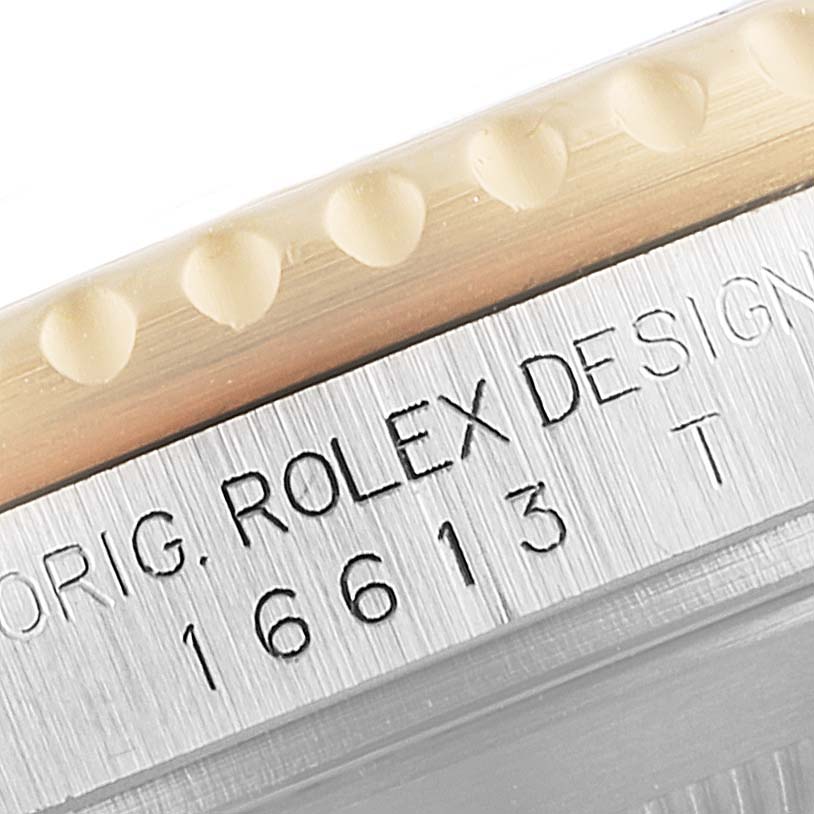 Close-up of the Rolex Submariner 16613 Men's Steel and Gold (two tone) Blue Dial 16613 Men's Steel and Gold (two tone) Blue Dial's model number and brand inscription on the side.