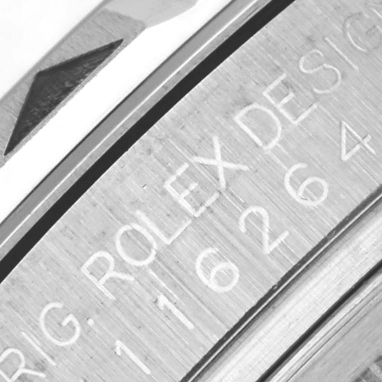 The image shows a close-up of the bezel and engraved serial number on a Rolex Turn-o-Graph 116264 Men's Stainless Steel White Dial 116264 Men's Stainless Steel White Dial watch.