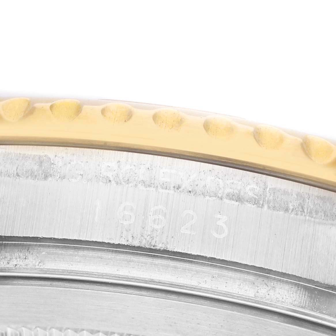 The image shows a close-up of the engraving on the side of the bezel and case for the Rolex Yacht-Master 16623 Men's Steel and Gold (two tone) White Dial watch.