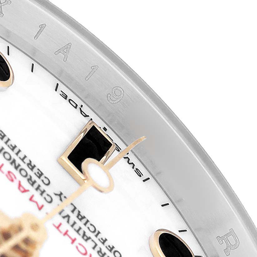 The close-up image shows the bezel, part of the face, and the hands of a Rolex Yacht-Master 16623 Men's Steel and Gold (two tone) White Dial watch at an angle.