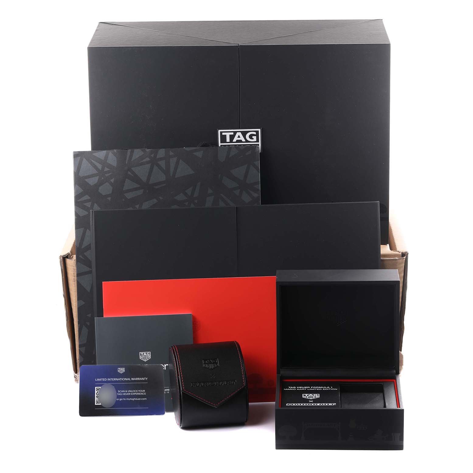 The image shows the packaging and accessories of the Tag Heuer CAZ201E.FC6517 Men
s Stainless Steel Black Dial CAZ201E.FC6517 Men
s Stainless Steel Black Dial Formula 1 Mario Kart Limited Edition watch, including boxes and cards.