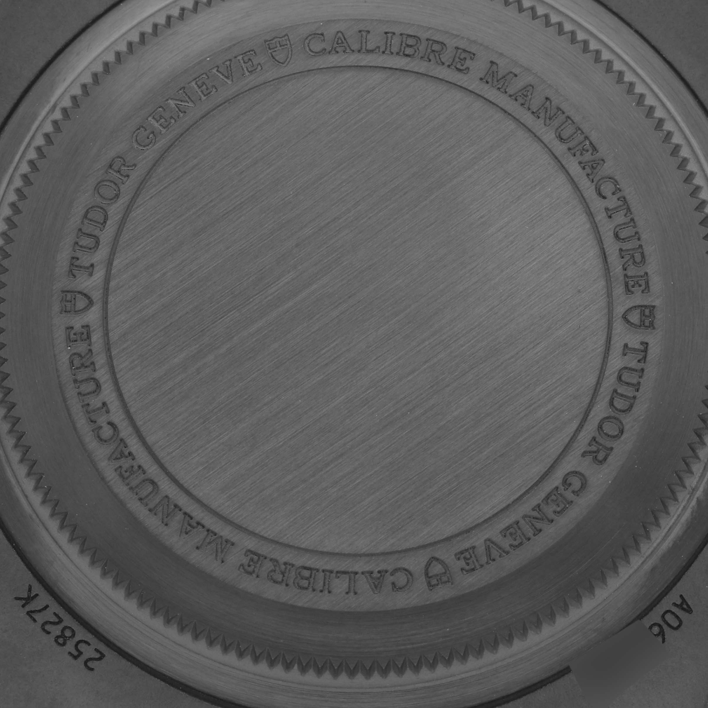 The image shows the case back of a Tudor Pelagos 25827KN Men
s Ceramic Black Dial 25827KN Men
s Ceramic Black Dial watch, highlighting its engraved details and brushed metal texture.