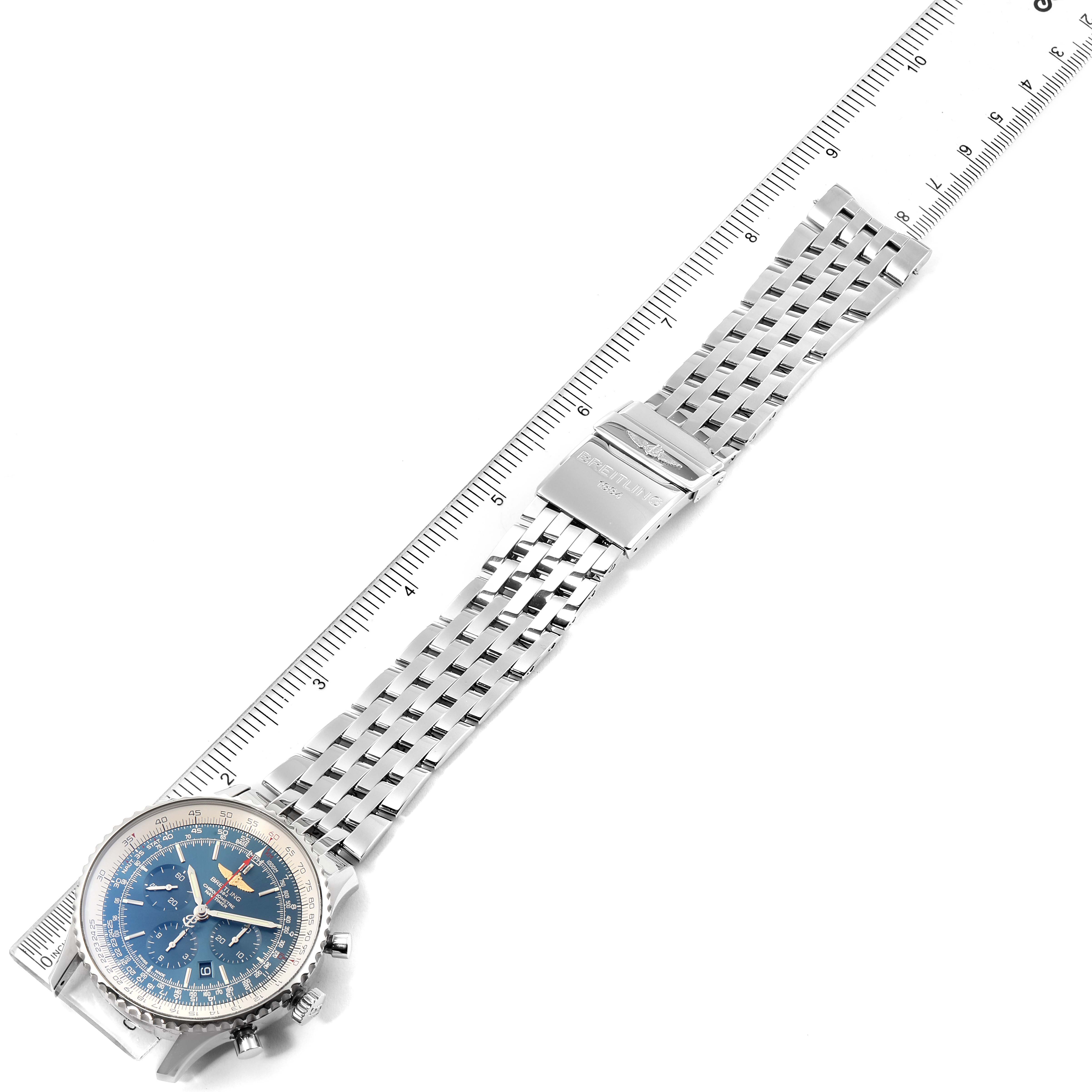 The image shows a Breitling Navitimer AB012721-C889-453A Men's Stainless Steel Blue Dial AB012721-C889-453A Men's Stainless Steel Blue Dial watch at an angle, highlighting its blue dial and stainless steel bracelet alongside a measurement ruler.