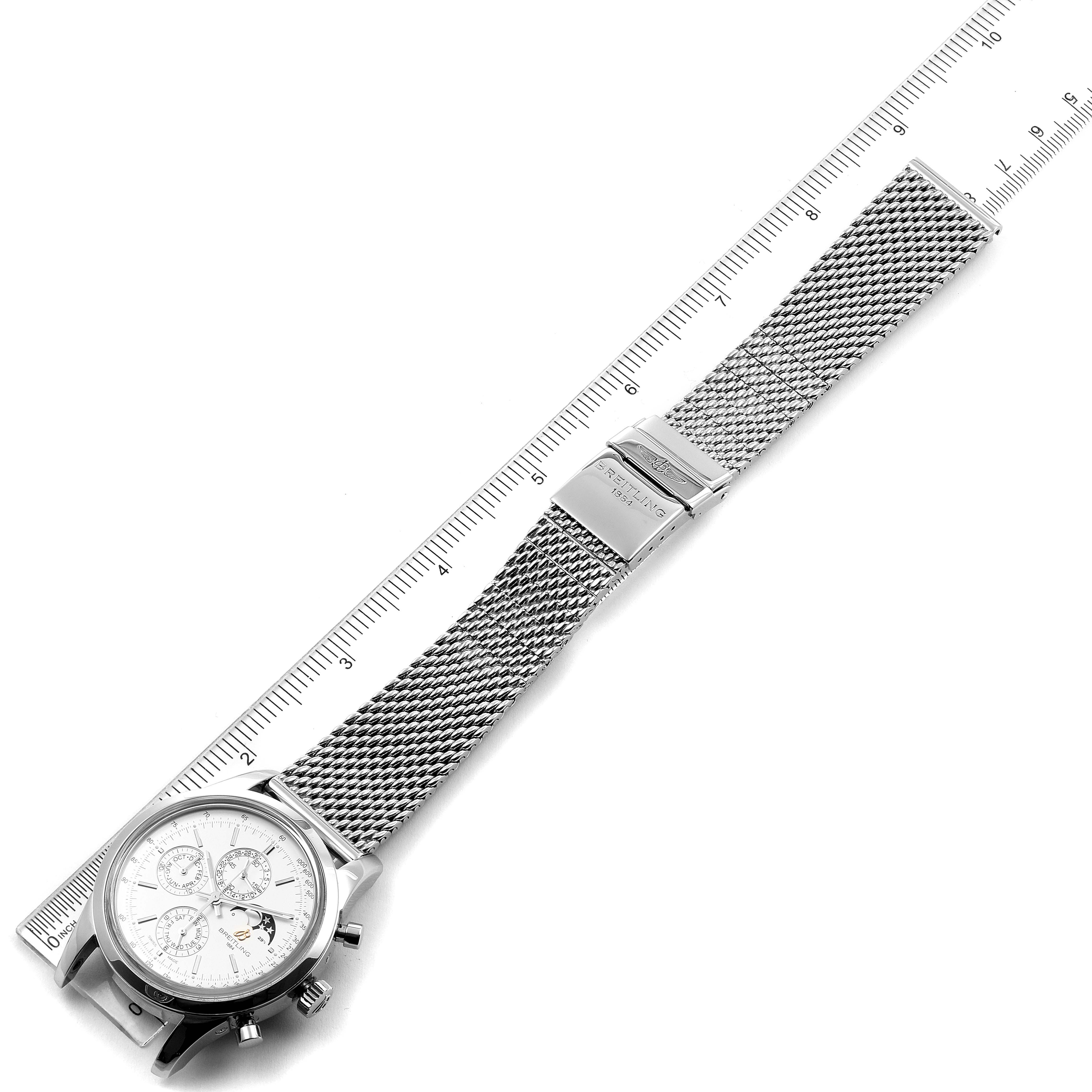 The image shows the Breitling Transocean A19310 Men's Stainless Steel Silver Dial A19310 Men's Stainless Steel Silver Dial watch at a side angle, focusing on the mesh strap and face, placed next to a ruler.