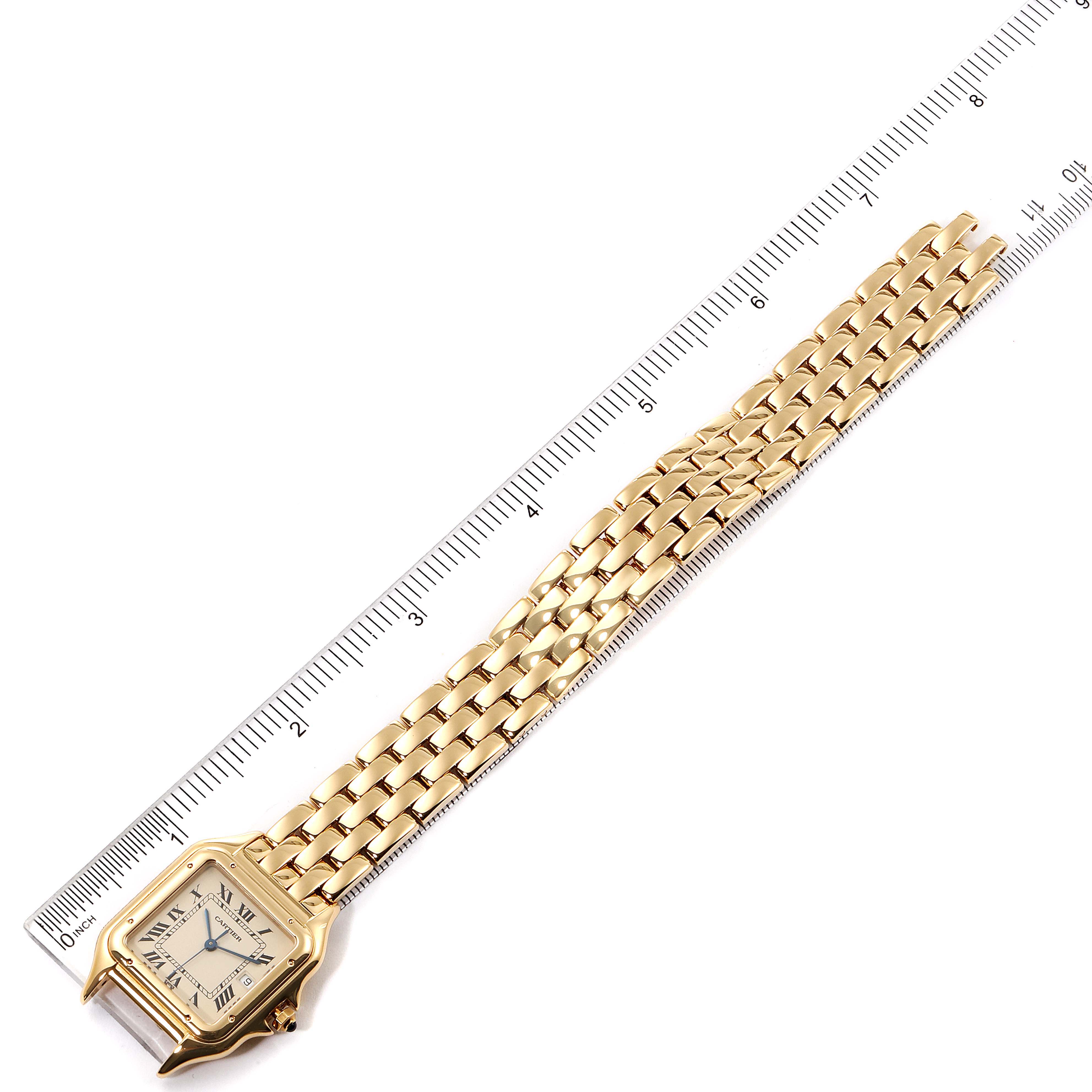 The image shows a Panthere model by Cartier from an overhead angle, displaying the watch face and bracelet on a ruler.