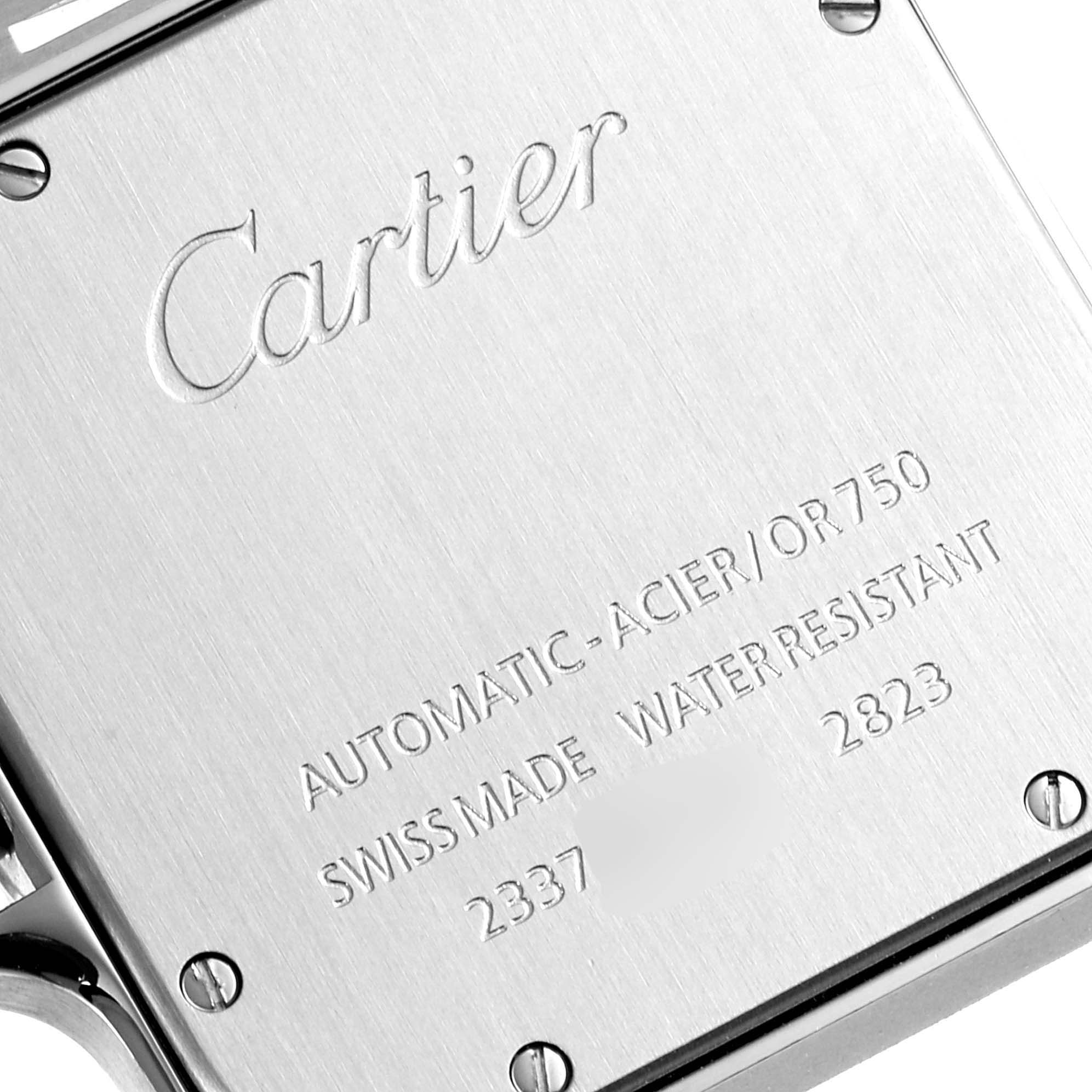 The image shows the back case of a Santos model watch by Cartier, highlighting engraved details and screws.