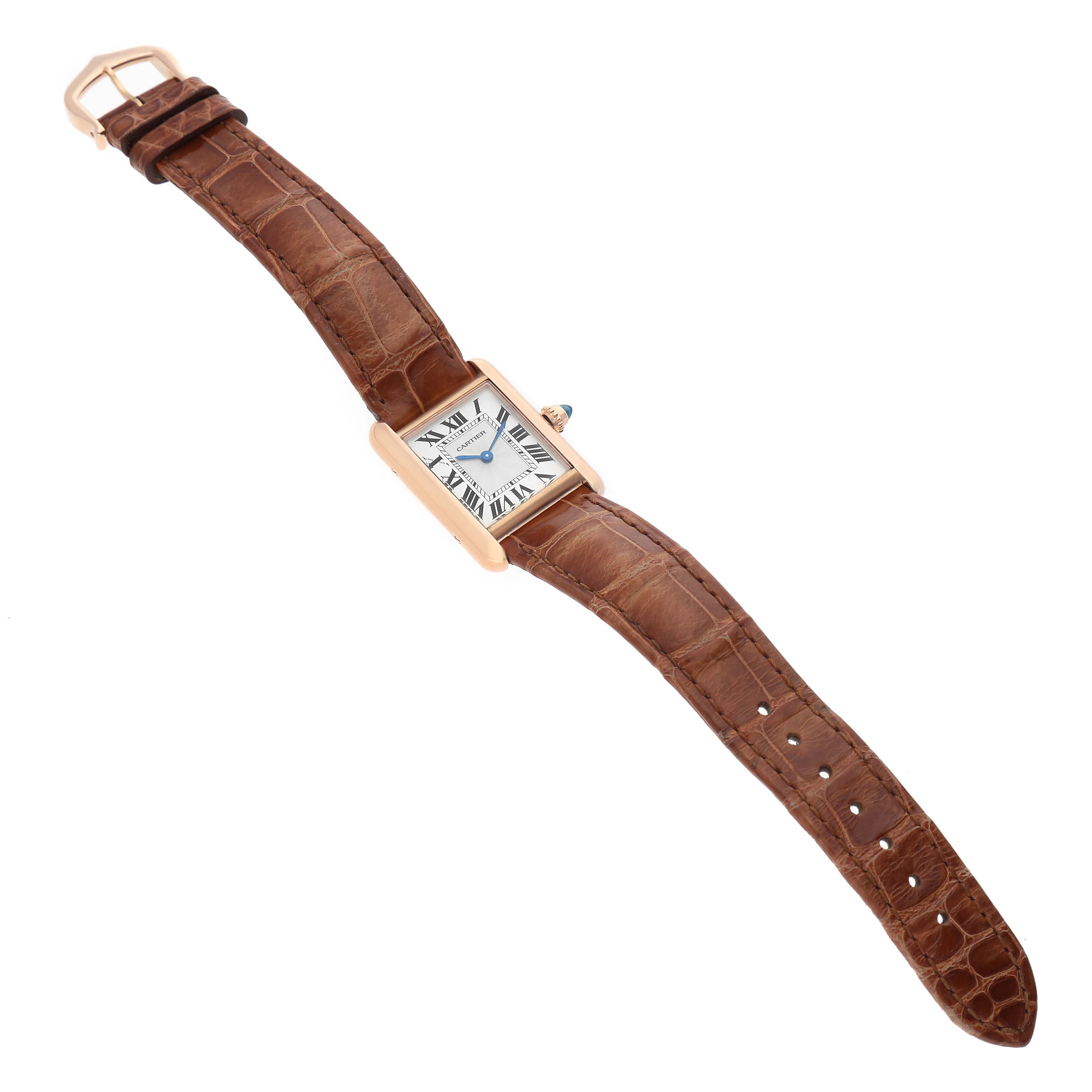 The Cartier Tank Louis WGTA0010 Women's Rose Gold Silver Dial watch is shown from a top angle, displaying its rectangular face and brown leather strap.