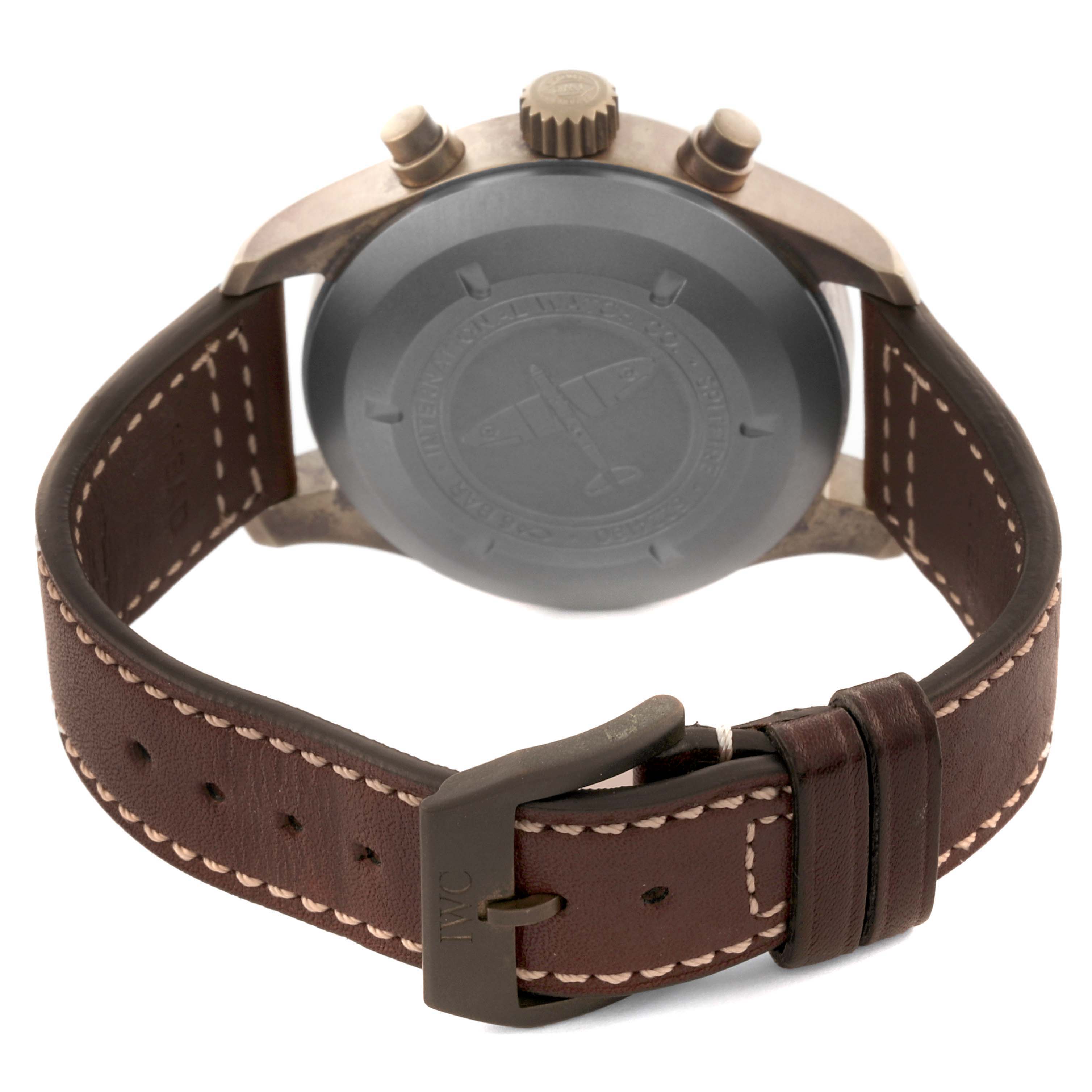The IWC Pilot IW387902 Men's Bronze Green Dial IW387902 Men's Bronze Green Dial watch is shown from the back, displaying the case back, crown, and part of the leather strap with buckle.
