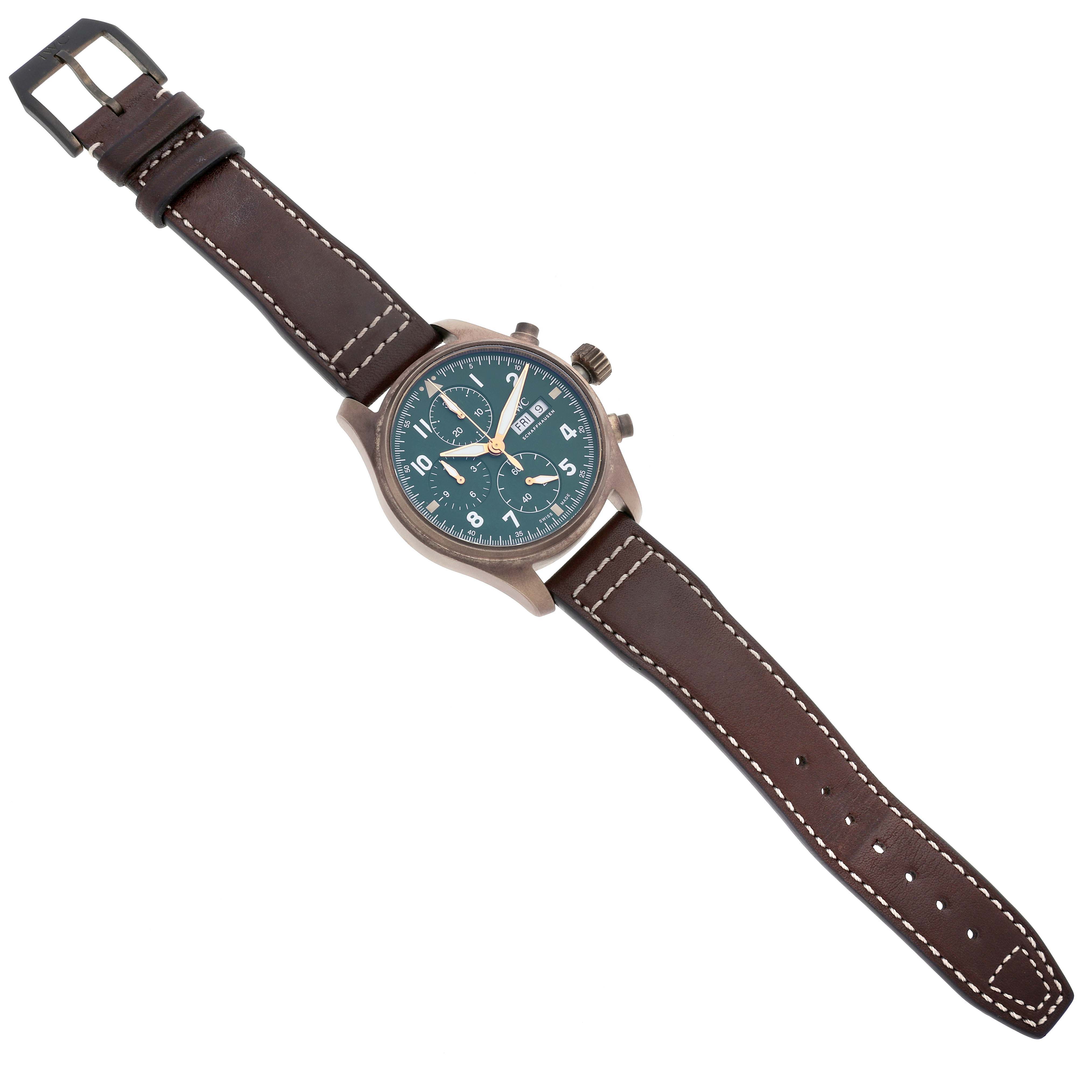 The IWC Pilot IW387902 Men's Bronze Green Dial IW387902 Men's Bronze Green Dial watch is shown from a top-down angle, displaying its dial, case, leather strap, and buckle.