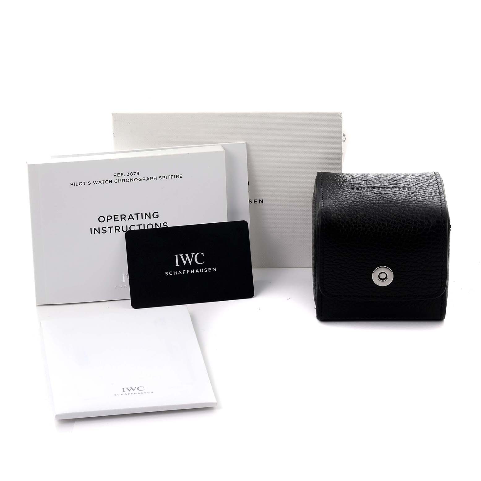 The image shows the IWC Pilot IW387902 Men's Bronze Green Dial IW387902 Men's Bronze Green Dial model accessories including a black leather case, manuals, and a warranty card from a frontal angle.