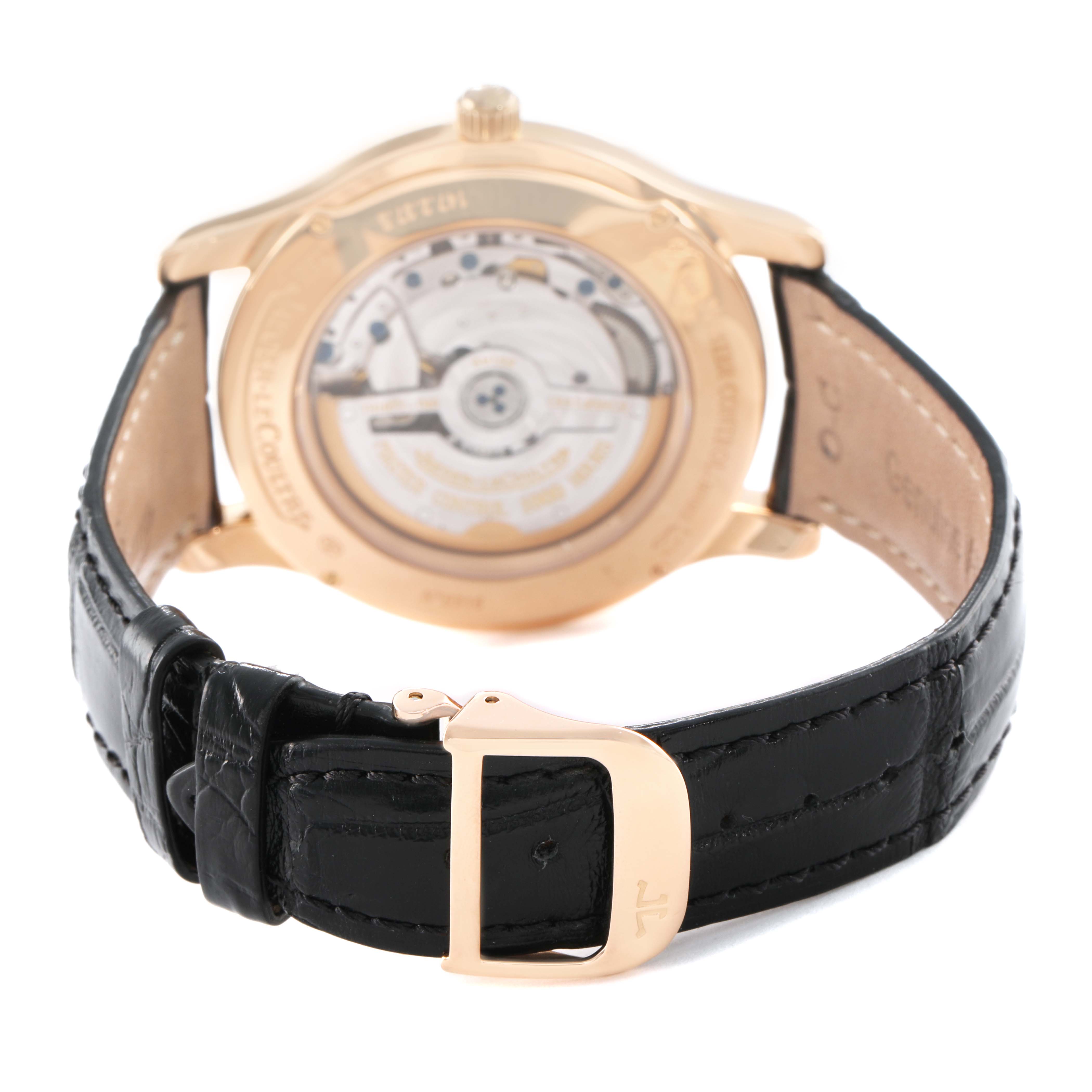 The Jaeger-LeCoultre Master watch is shown from the rear, highlighting the movement, case back, and black leather strap with buckle.