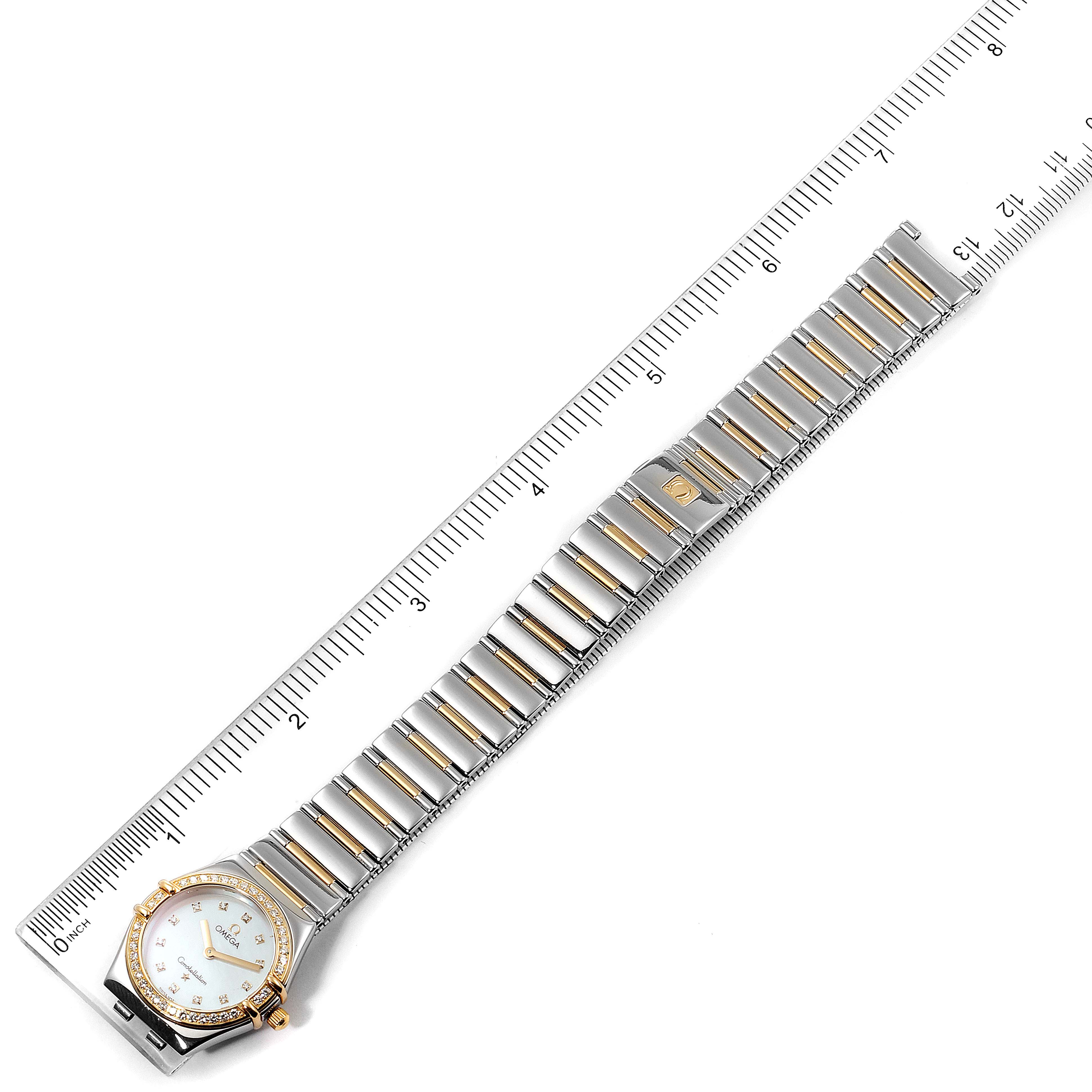 The Omega 1376.71.00 Women's Steel and Gold (two tone) Mother of Pearl Dial 1376.71.00 Women's Steel and Gold (two tone) Mother of Pearl Dial Constellation My Choice Steel Yellow Gold Diamond Watch 1376.71.00 is shown flat with the face on the left and a ruler for scale.