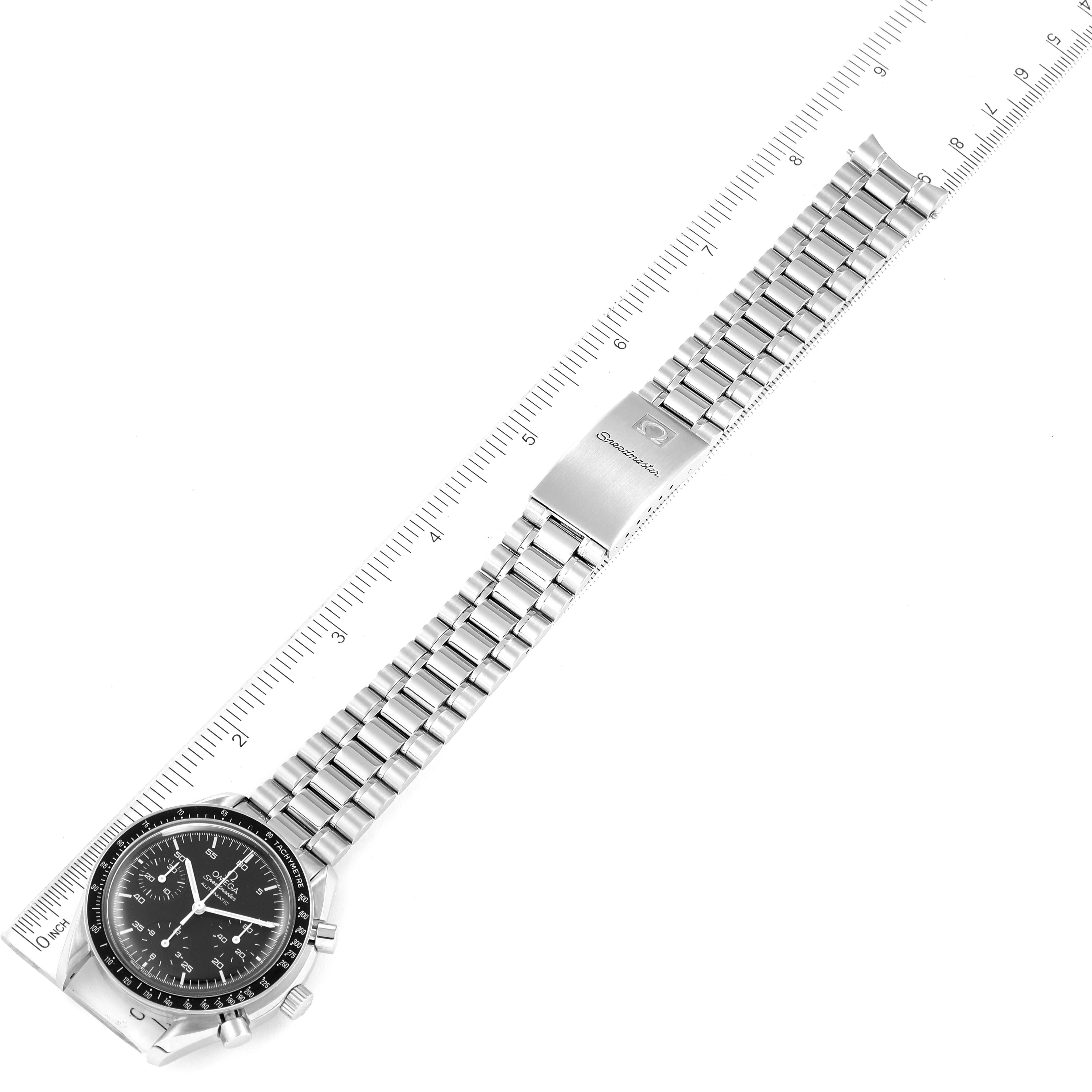 The image shows a top-down view of an Omega Speedmaster 3510.50.00 Men
s Stainless Steel Black Dial 3510.50.00 Men
s Stainless Steel Black Dial watch with a stainless steel bracelet and clasp, placed alongside a ruler for measurement.