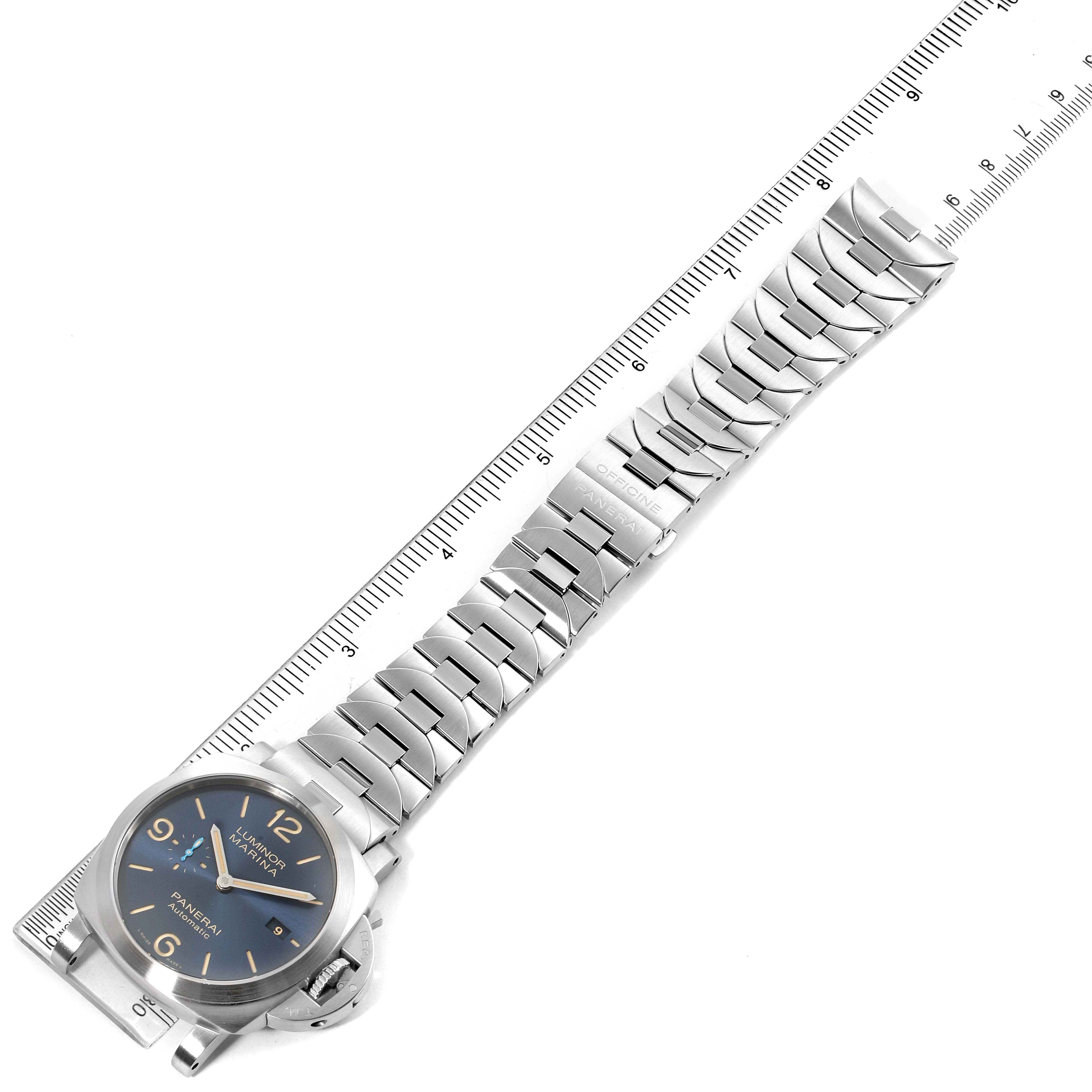 The image shows a Panerai Luminor PAM01058 Men's Stainless Steel Blue Dial PAM01058 Men's Stainless Steel Blue Dial watch and its metal bracelet laid flat next to a ruler, viewed from a top-down angle.