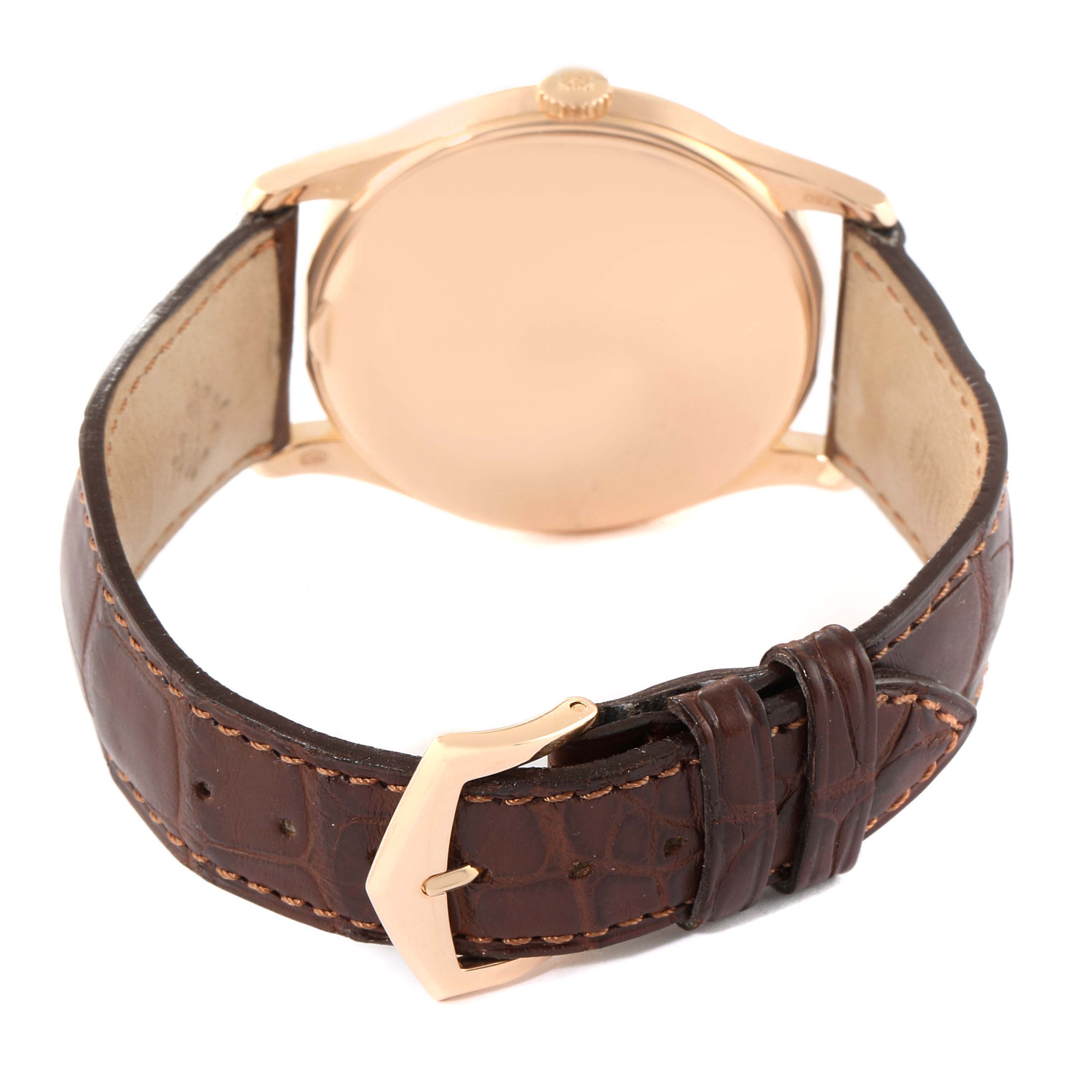 The image shows the back view of a Patek Philippe Calatrava 5196R Men's Rose Gold Silver Dial 5196R Men's Rose Gold Silver Dial watch with a brown leather strap and a gold case.