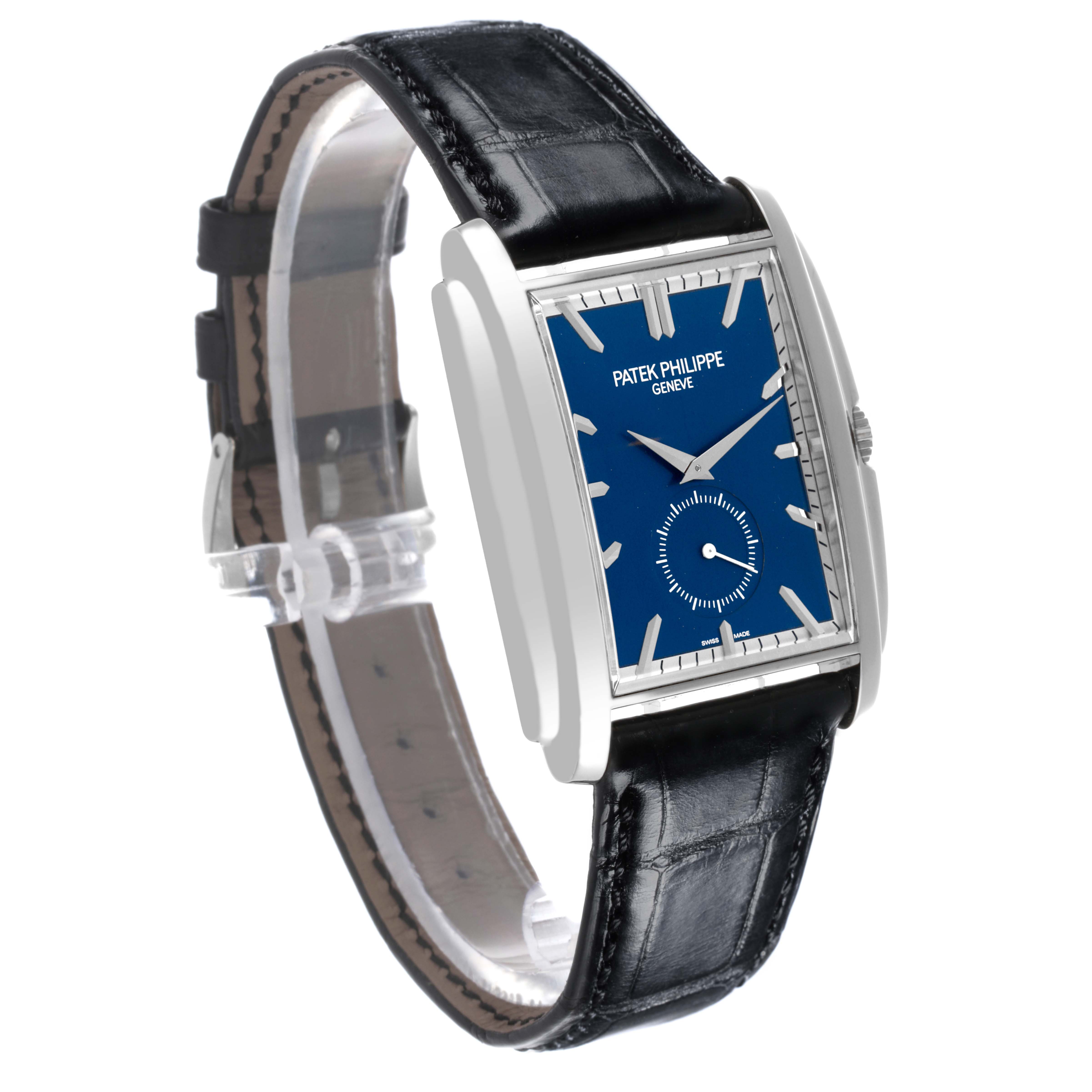 The Patek Philippe Gondolo 5124G-011 Men's White Gold Blue Dial 5124G-011 Men's White Gold Blue Dial watch is shown at an oblique angle, highlighting the blue dial, rectangular case, and black leather strap.