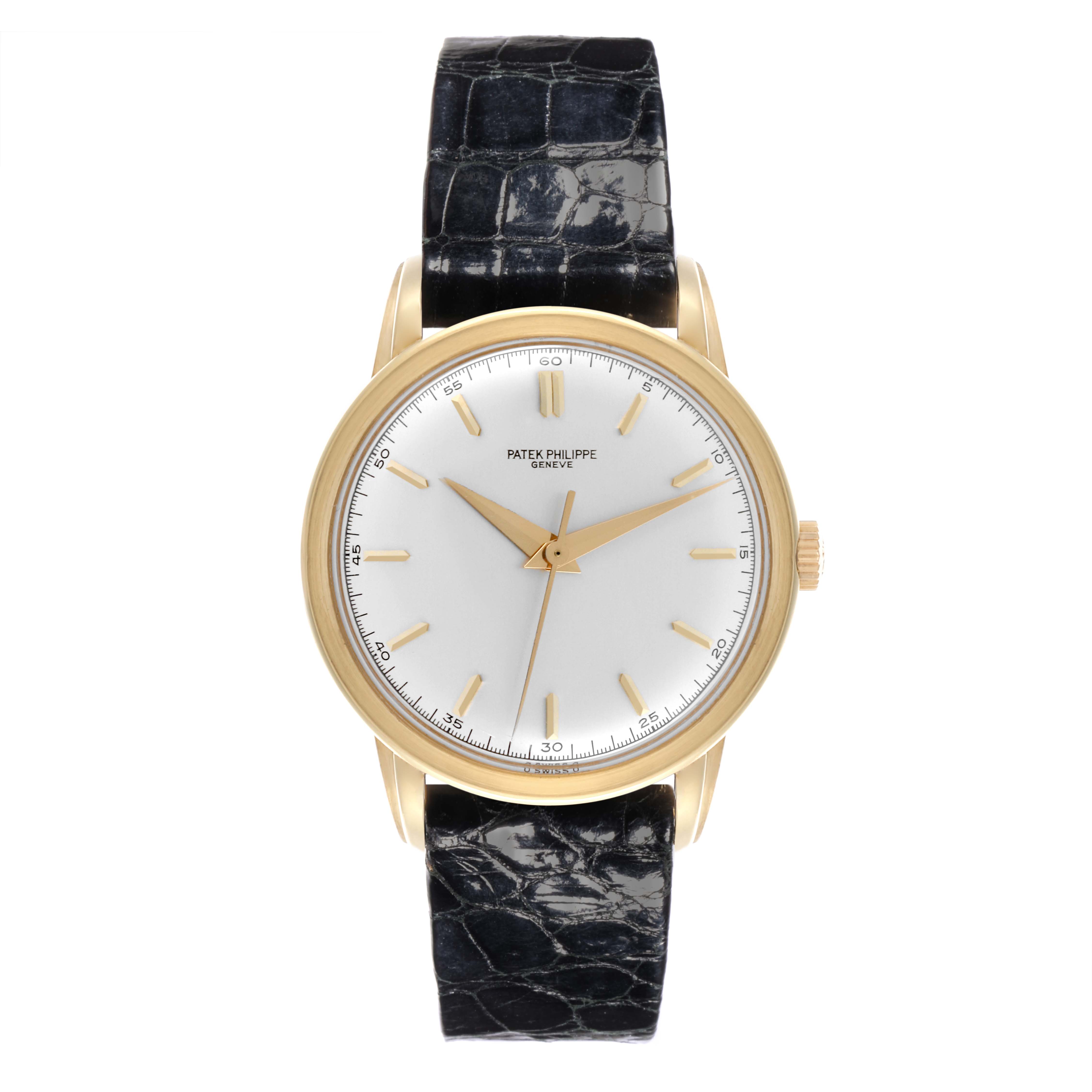 The Patek Philippe Calatrava 2481 Men's Yellow Gold Silver Dial watch is shown from a top-down angle, highlighting the face, hour markers, hands, and leather strap.
