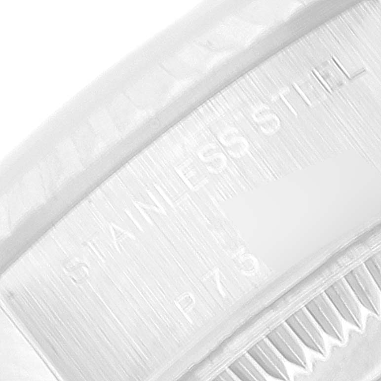 This image shows a close-up of the engraved text "STAINLESS STEEL" on the caseback of a Rolex Datejust 79174 Women's Stainless Steel Silver Dial 79174 Women's Stainless Steel Silver Dial watch.