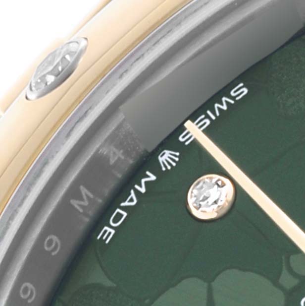 The image shows a close-up of the Rolex Mid-Size 278343RBR-0032 Women's Steel and Gold (two tone) Green Dial 278343RBR-0032 Women's Steel and Gold (two tone) Green Dial watch, highlighting part of the dial, a jeweled hour marker, and the bezel.