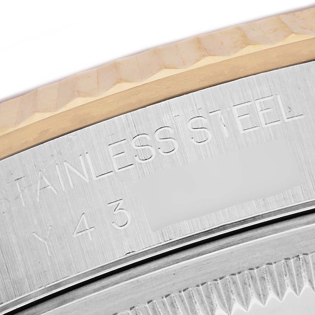 The image shows a close-up of the side view of a Rolex Datejust 16233 Men's Steel and Gold (two tone) Mother of Pearl Dial 16233 Men's Steel and Gold (two tone) Mother of Pearl Dial bezel and part of the case, with engraved text visible.