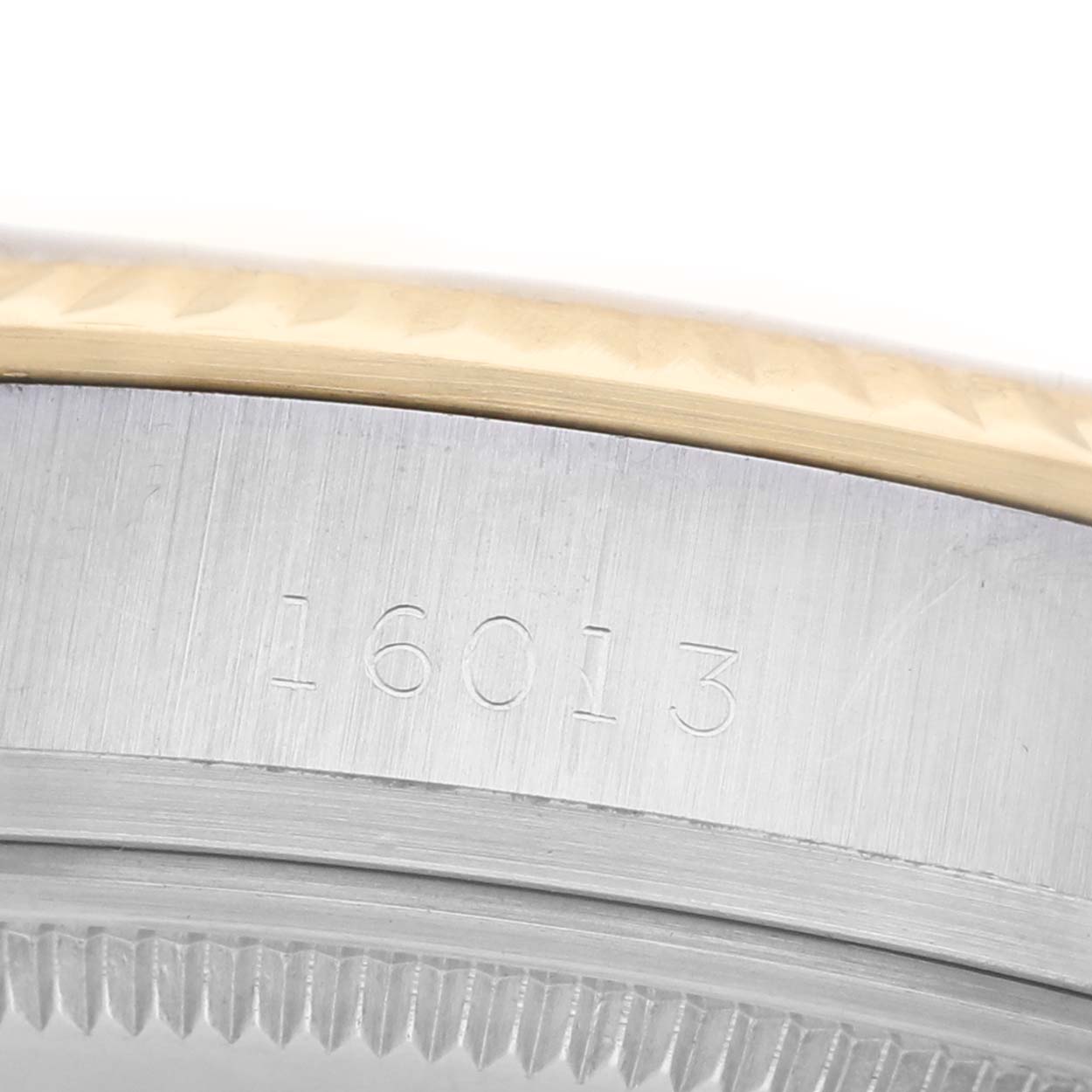 This image shows a close-up of the side of a Rolex Datejust 16013 Men's Stainless Steel Champagne Dial watch, highlighting the case reference number engraved on the metal.
