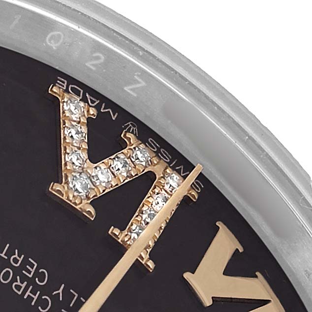 The image shows a close-up of a Rolex Mid-Size 278273 Women's Steel and Gold (two tone) Grey Dial watch face, highlighting a jeweled Roman numeral and the minute hand.