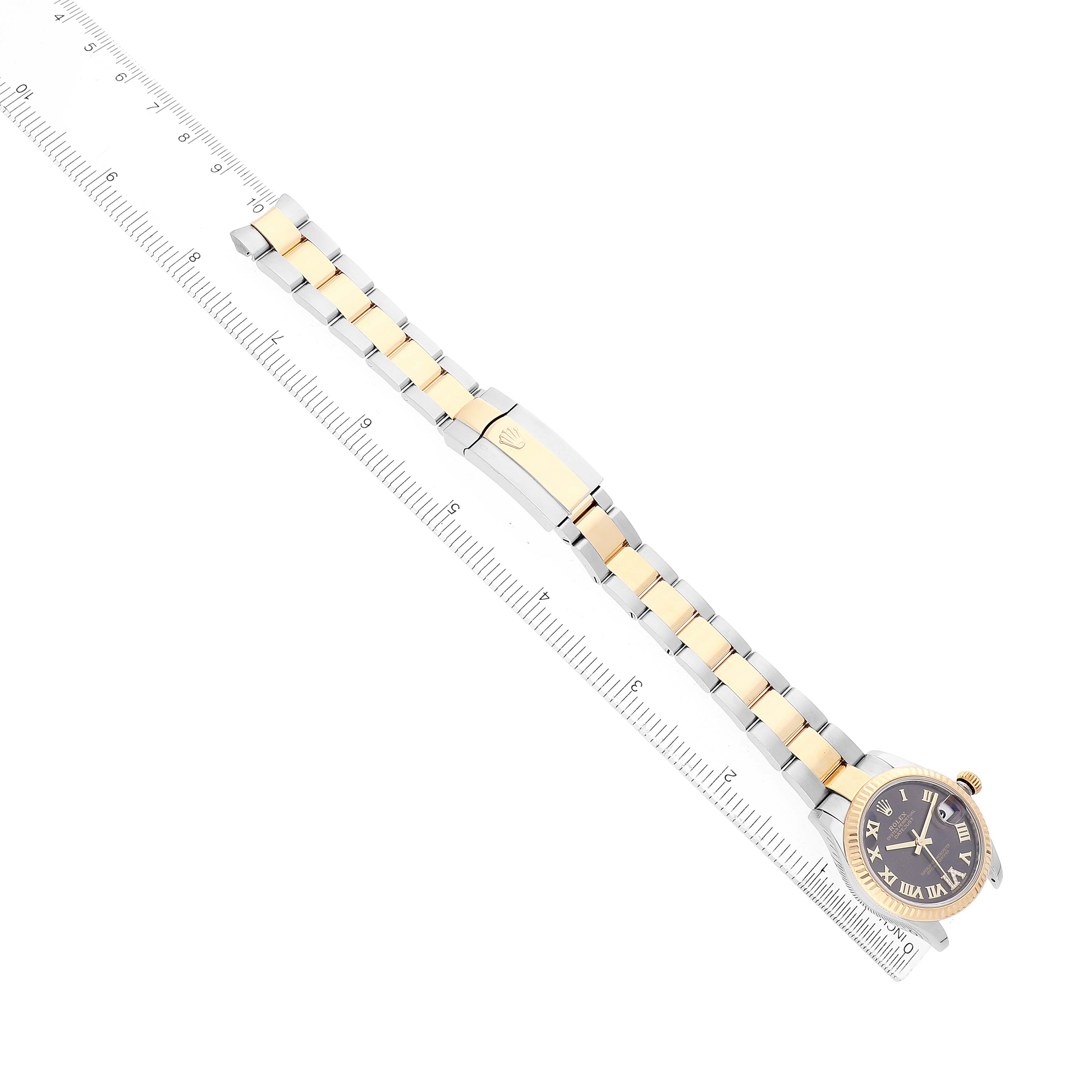 The Rolex Mid-Size 278273 Women's Steel and Gold (two tone) Grey Dial watch is shown at an overhead angle, displaying the band, clasp, and watch face next to a ruler for scale.