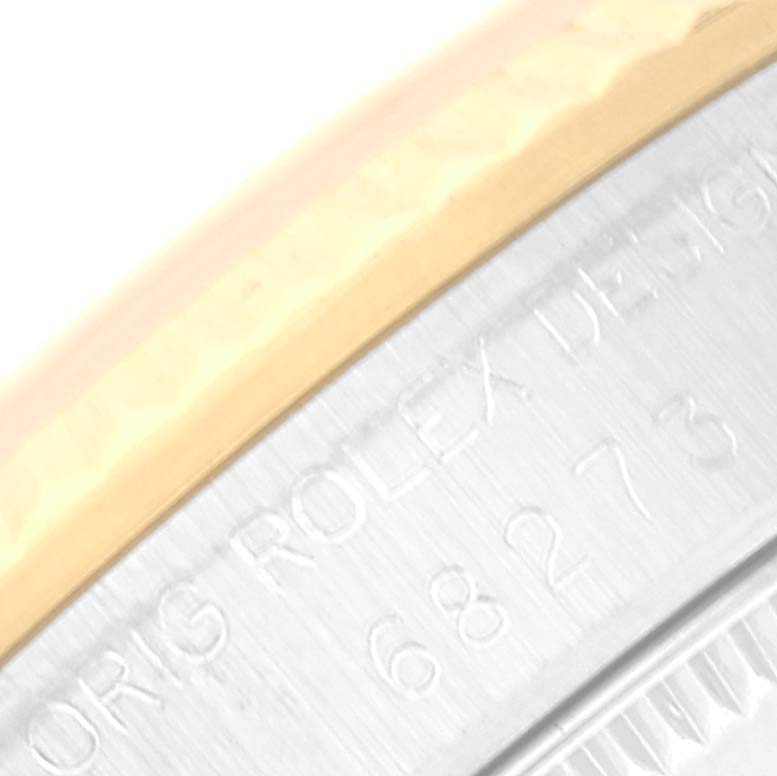 This close-up image shows part of the bezel and side of a mid-size Rolex watch, with the engraved model number visible.