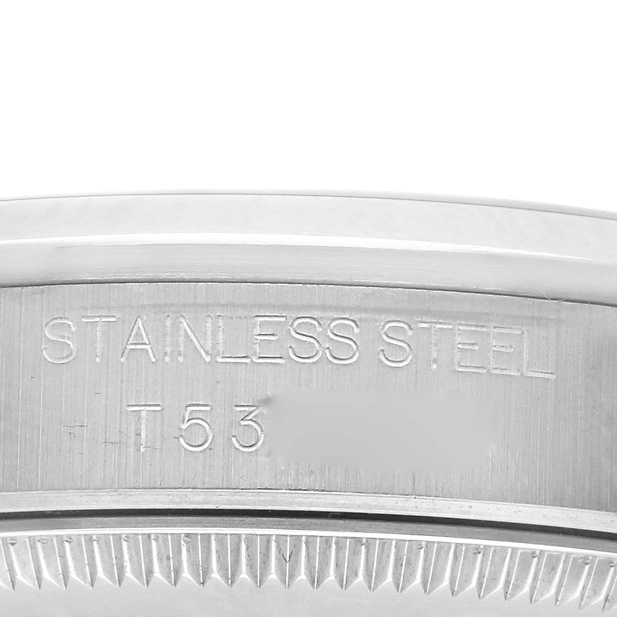 The image shows a close-up of the etched stainless steel rim of a Rolex Mid-Size 68240 Women
s Stainless Steel White Dial 68240 Women
s Stainless Steel White Dial watch.