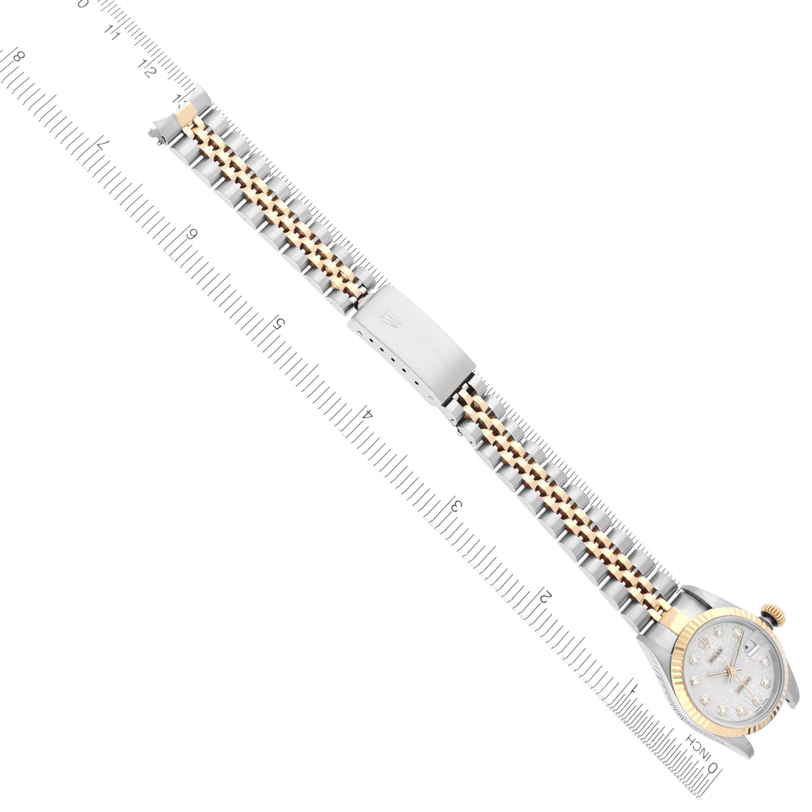 The Rolex Datejust 69173 Women's Steel and Gold (two tone) Silver Dial 69173 Women's Steel and Gold (two tone) Silver Dial watch is shown from a top-down angle with the face, bracelet, and clasp visible alongside a ruler for scale.