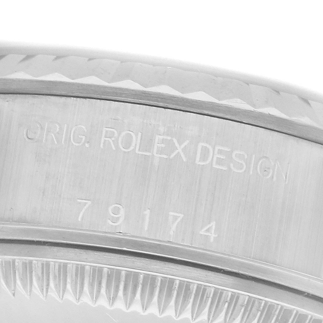 The image shows a macro view of the Rolex Datejust 79174 Women's Stainless Steel Silver Dial's case side, highlighting the engraving and part of the bezel.