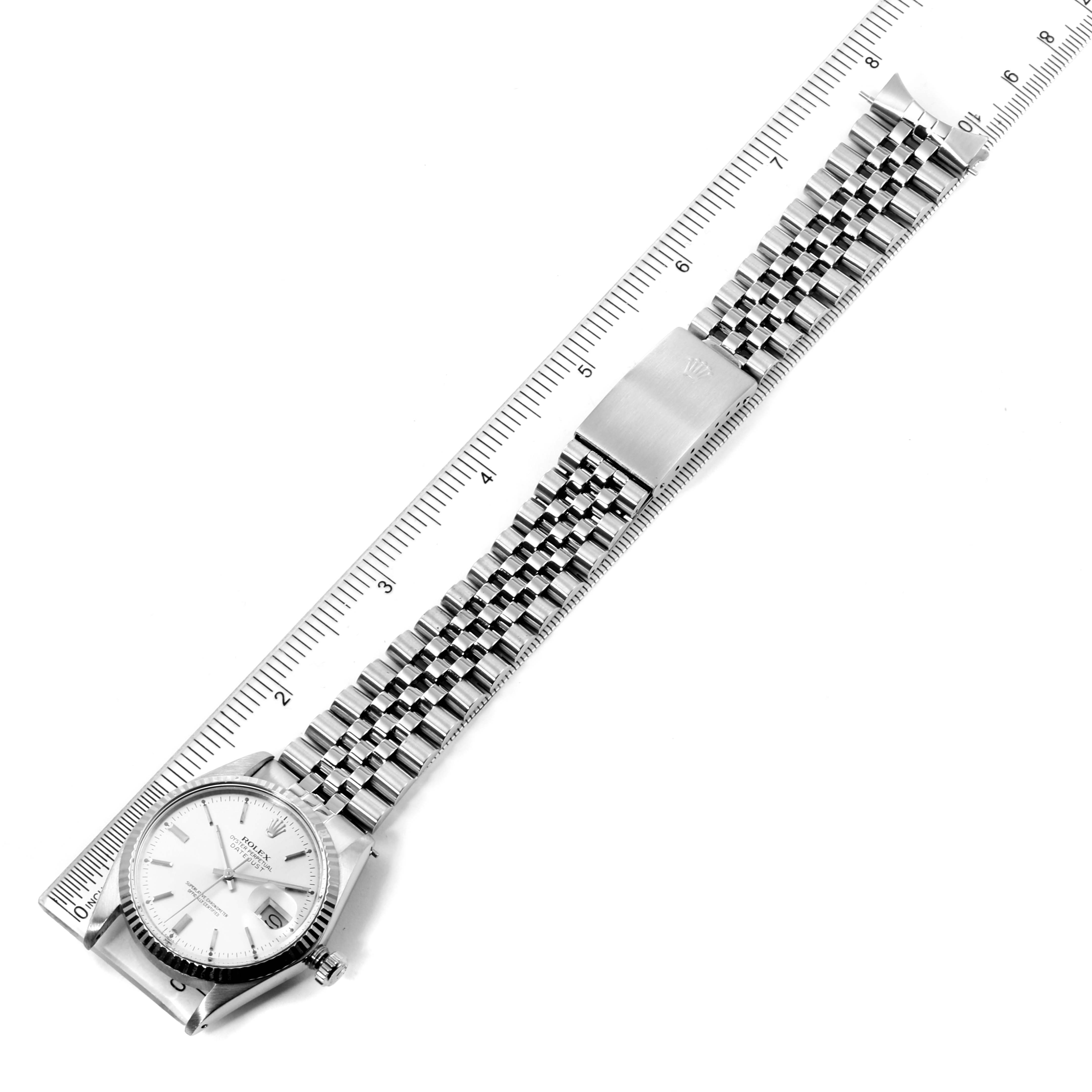 The image shows a top-down view of a Rolex Vintage Collection 16014 Men's Stainless Steel Silver Dial 16014 Men's Stainless Steel Silver Dial watch, highlighting the dial and metal bracelet with a measurement ruler.