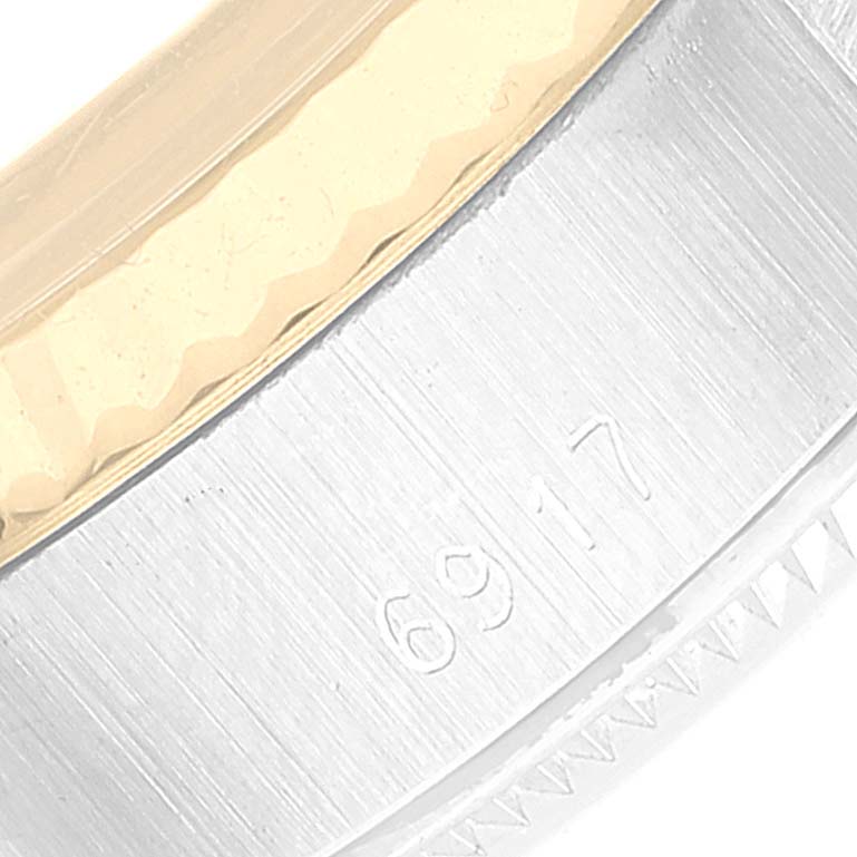 This close-up shows the side of the bezel and case of a Rolex Datejust 6917 Women's Steel and Gold (two tone) Champagne Dial 6917 Women's Steel and Gold (two tone) Champagne Dial watch, highlighting the model number "6917."