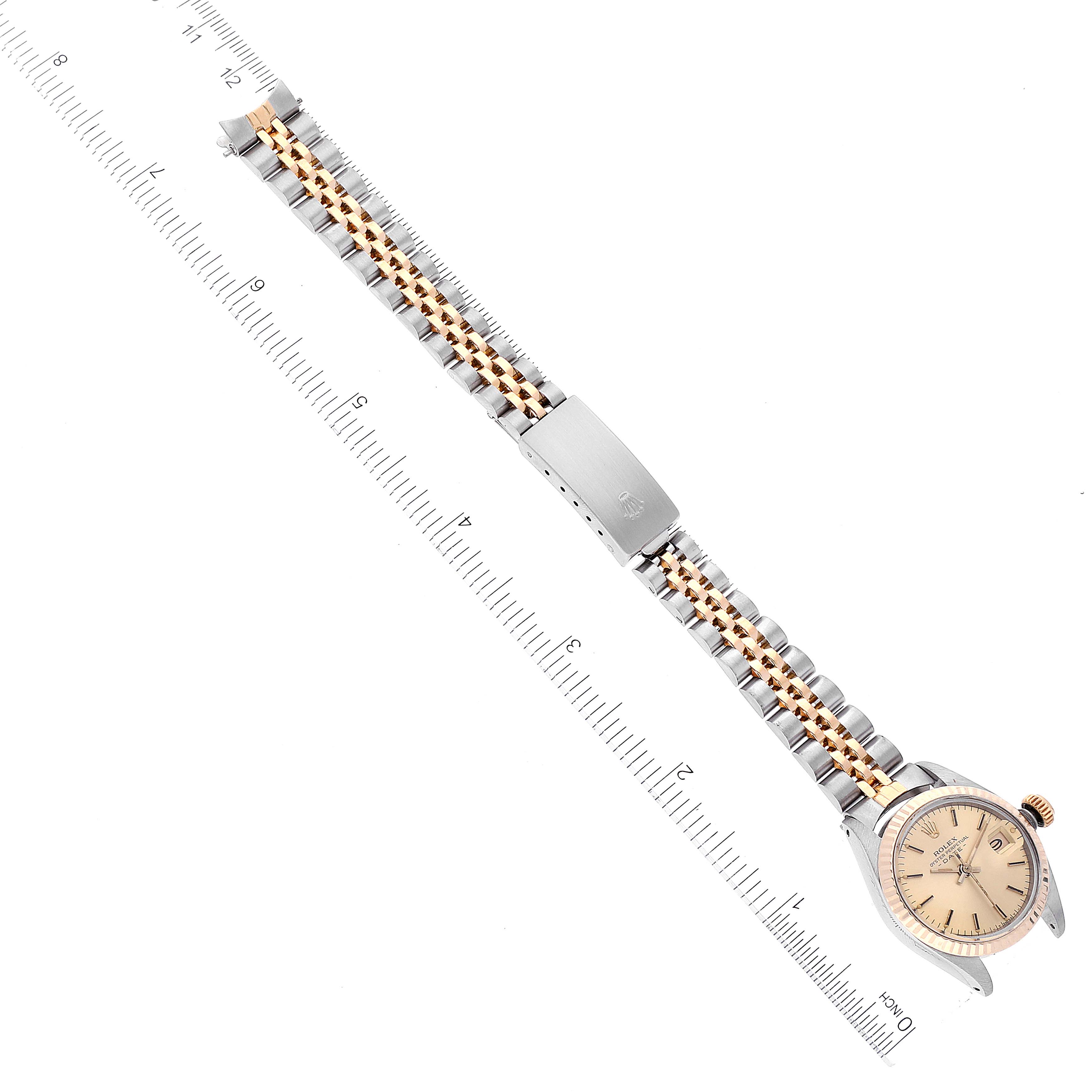 The Rolex Datejust 6917 Women's Steel and Gold (two tone) Champagne Dial 6917 Women's Steel and Gold (two tone) Champagne Dial watch is shown in a top-down view, displaying the entire watch including the face, bezel, bracelet, and clasp.