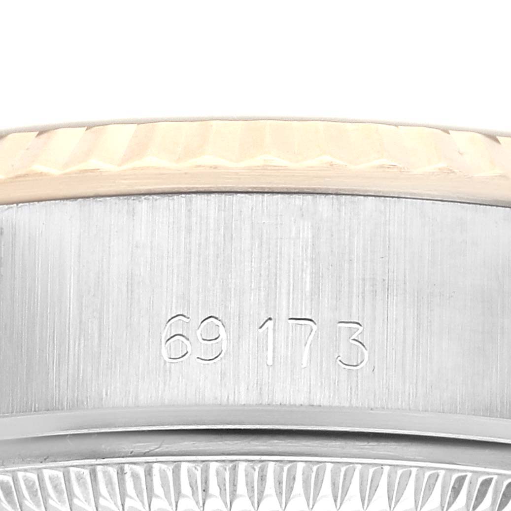 The image shows a side view of the Rolex Datejust 69173 Women's Steel and Gold (two tone) Champagne Dial 69173 Women's Steel and Gold (two tone) Champagne Dial, highlighting the case's edge, engraved model number, and part of the bezel.