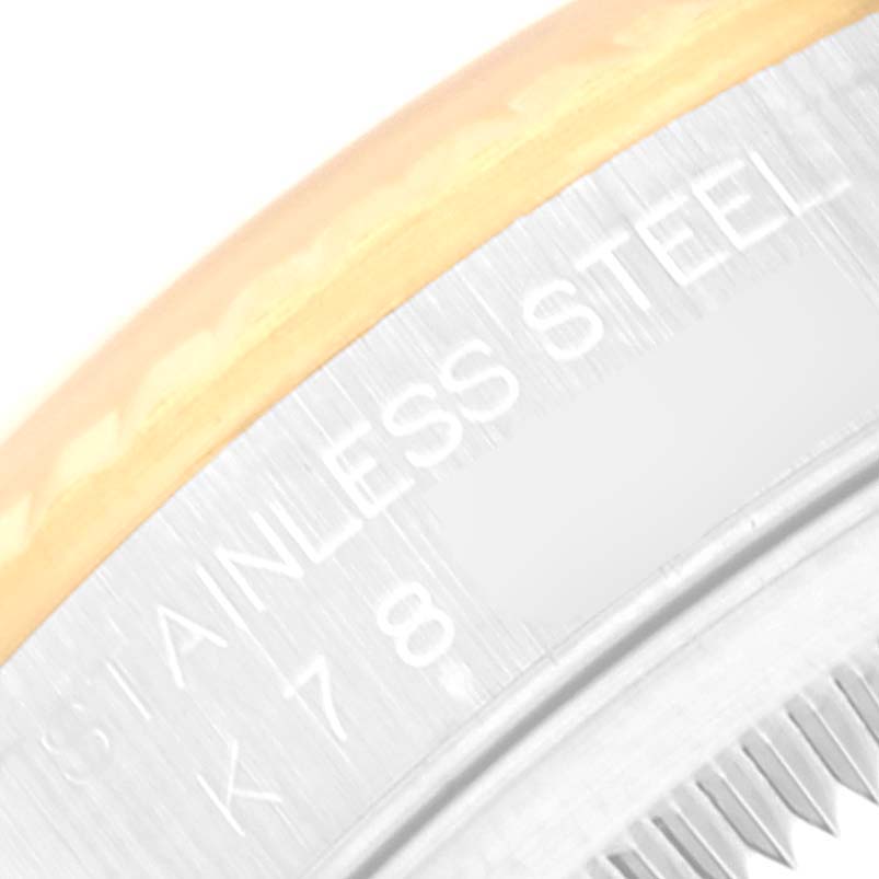 This image shows a close-up of the bezel and part of the rehault on a Rolex Datejust 16233 Men's Steel and Gold (two tone) Silver Dial 16233 Men's Steel and Gold (two tone) Silver Dial watch, highlighting the "STAINLESS STEEL" engraving.