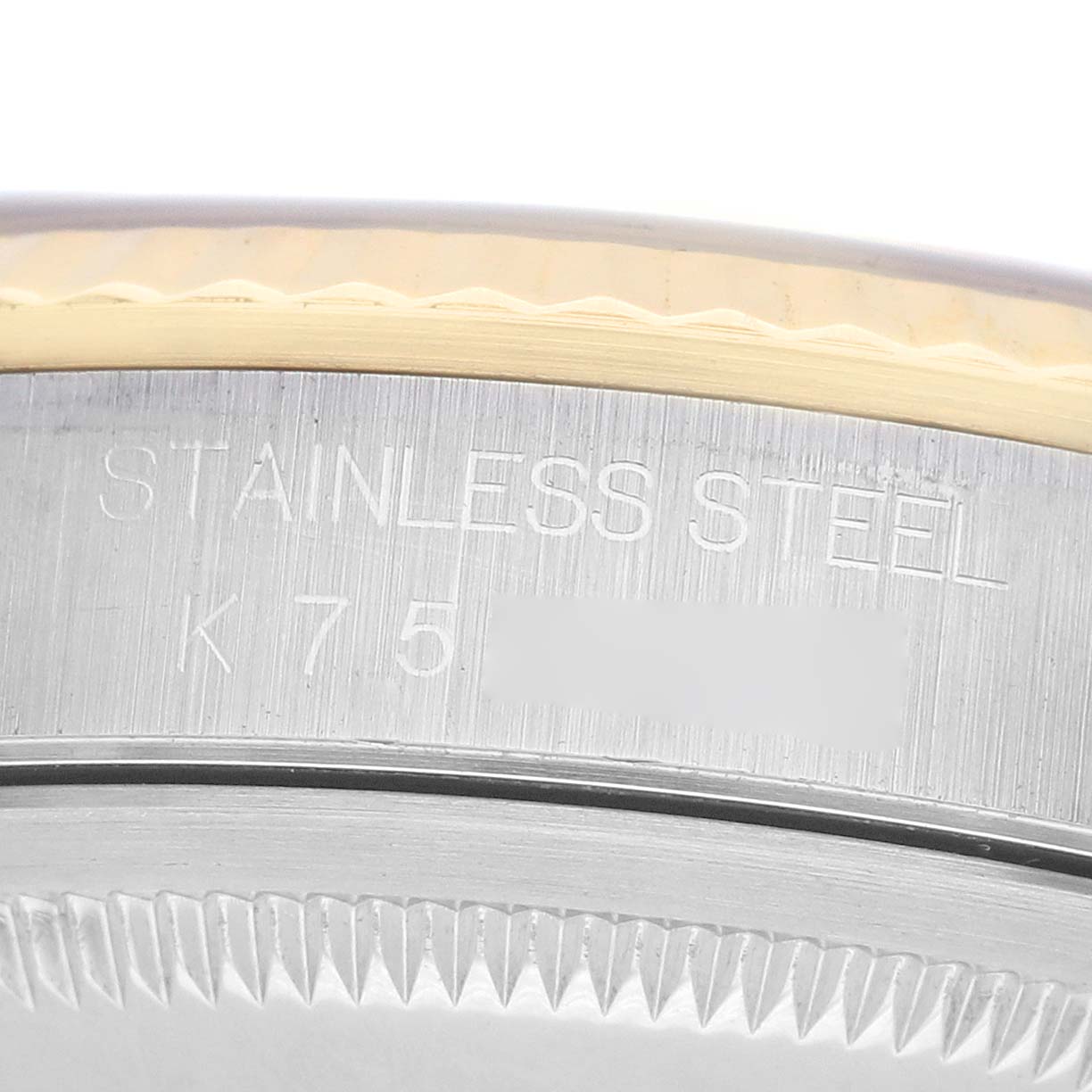 The image shows a close-up of the side engraving on a Rolex Datejust 16233 Men's Steel and Gold (two tone) Grey Dial watch, highlighting its stainless steel material.