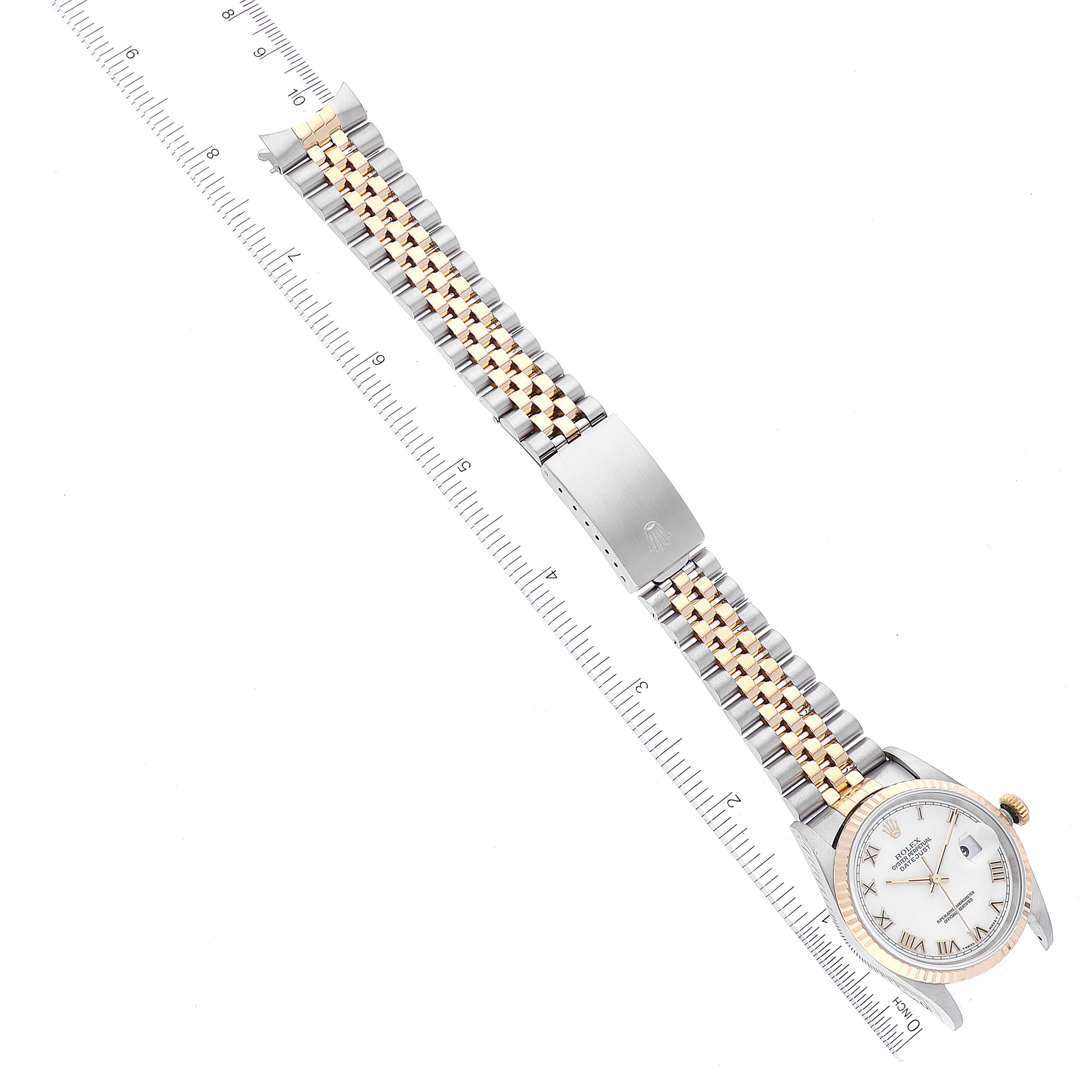 This image shows a Rolex Datejust 16233 Men's Steel and Gold (two tone) White Dial 16233 Men's Steel and Gold (two tone) White Dial watch at a top-down angle, highlighting the face, bezel, and jubilee bracelet alongside a ruler.