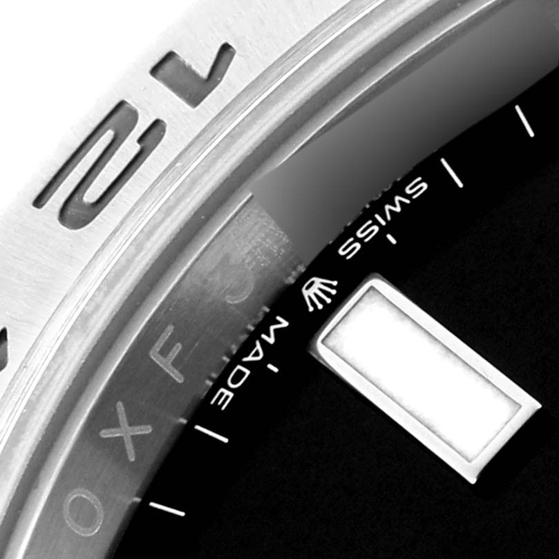 The image shows a close-up of the bezel and part of the dial of a Rolex Explorer M226570-0002 Men's Stainless Steel Black Dial M226570-0002 Men's Stainless Steel Black Dial watch, highlighting "Swiss Made."