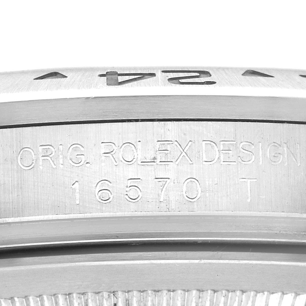 The image shows a close-up of the Rolex Explorer 16570 Men
s Stainless Steel White Dial 16570 Men
s Stainless Steel White Dial’s case side engraving, featuring "ORIG. ROLEX DESIGN 16570 T".