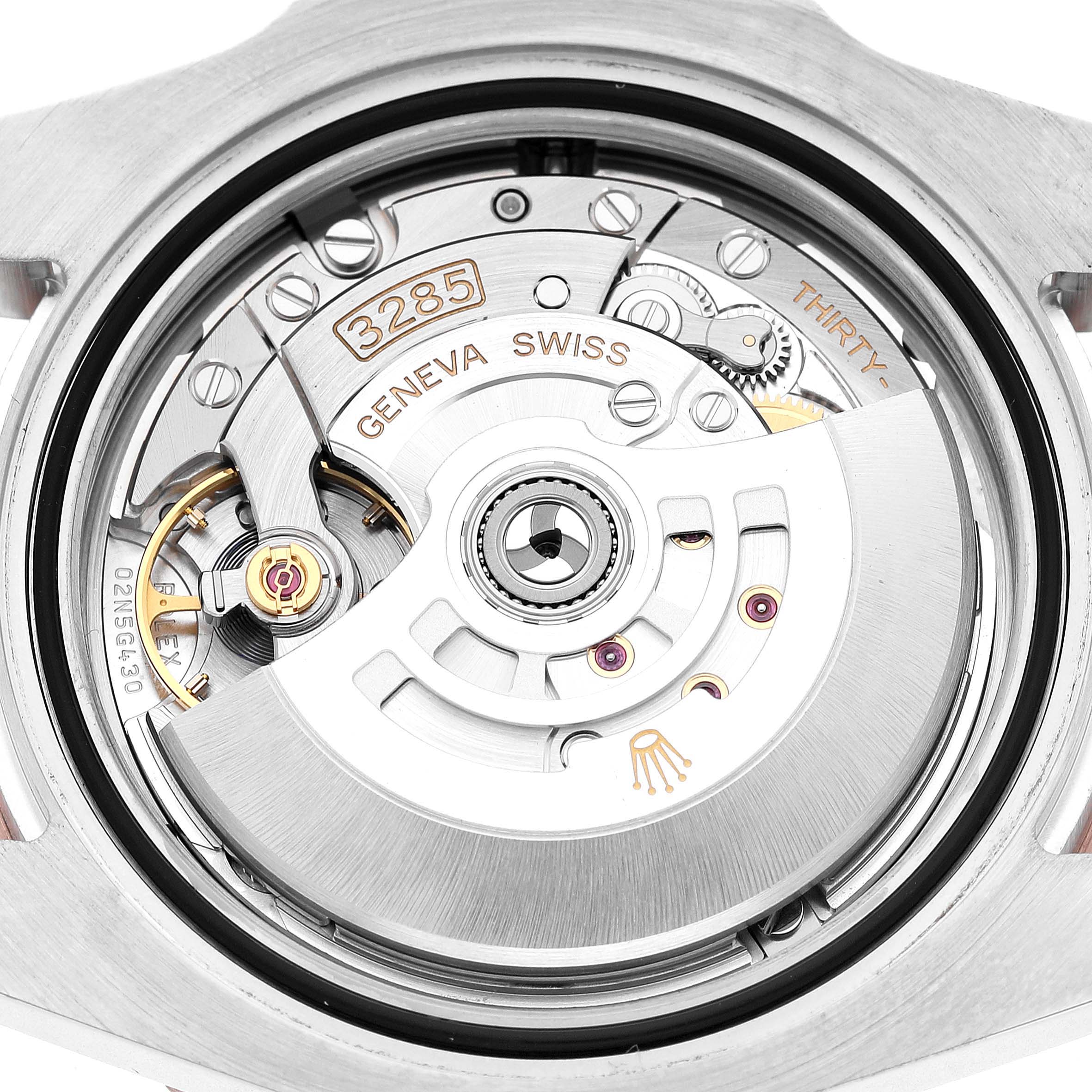 The image shows the movement of a Rolex GMT-Master 126711 Men's Steel and Gold (two tone) Black Dial, highlighting the rotor and intricate inner mechanics.